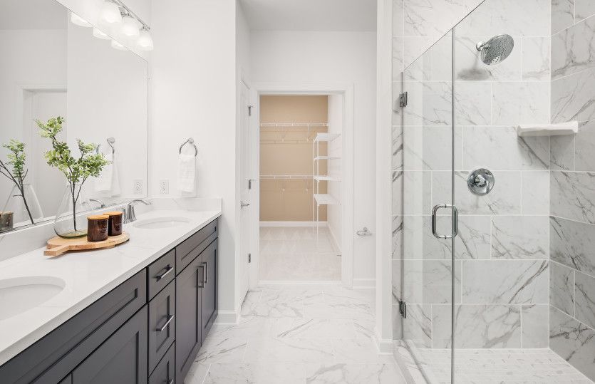 Owner's Bath with Dual Sinks and a Frameless Walk-in Shower