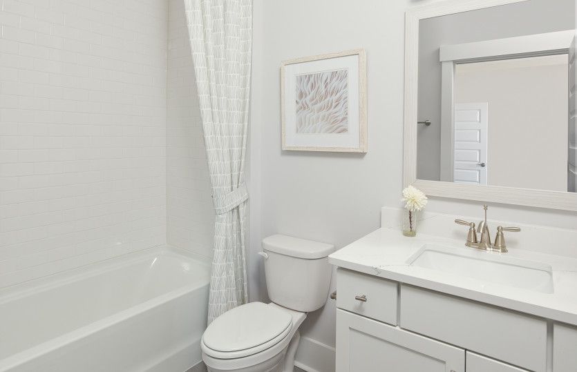 Bright white Secondary bath with a soaking tub.