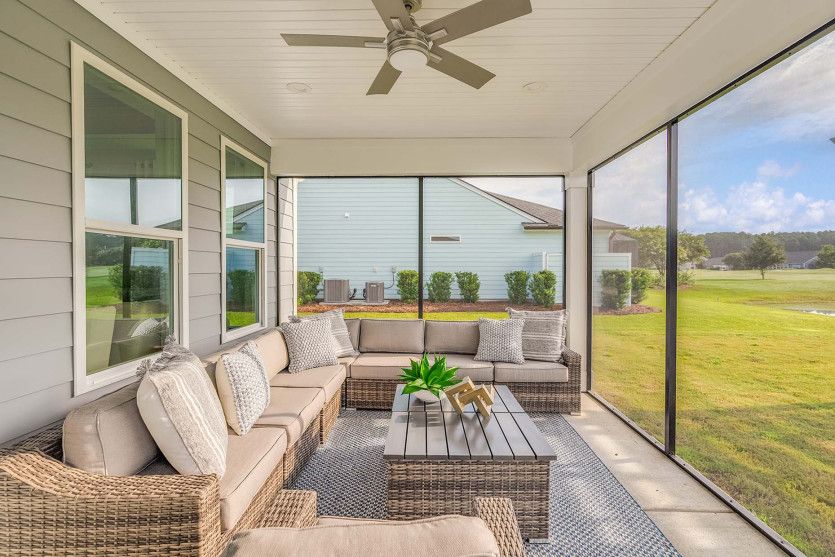 Screened porch with attached patio overlooking the backyard