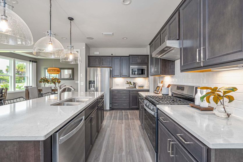 Double ovens with cooktop and range hood, as well as a microwave complete the new construction kitch