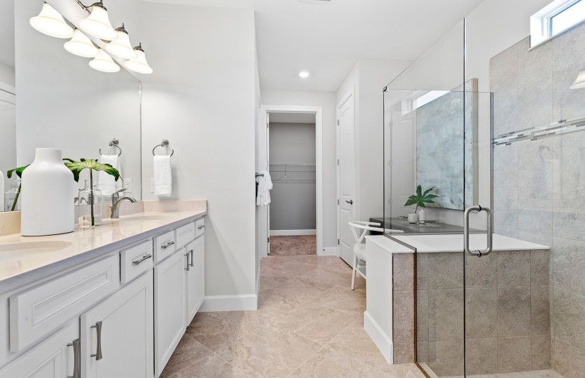 Owner's bathroom with dual sink vanity and large shower