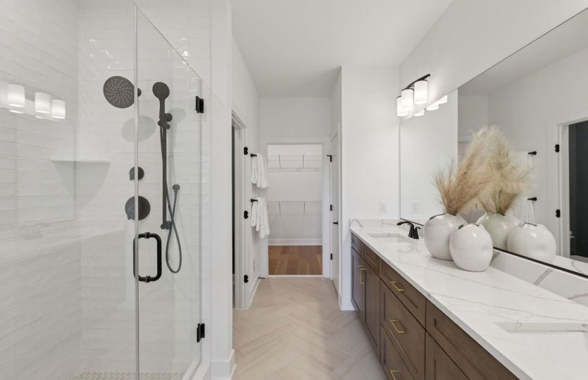 Luxurious Owner's Bath with a Frameless Walk-in Shower
