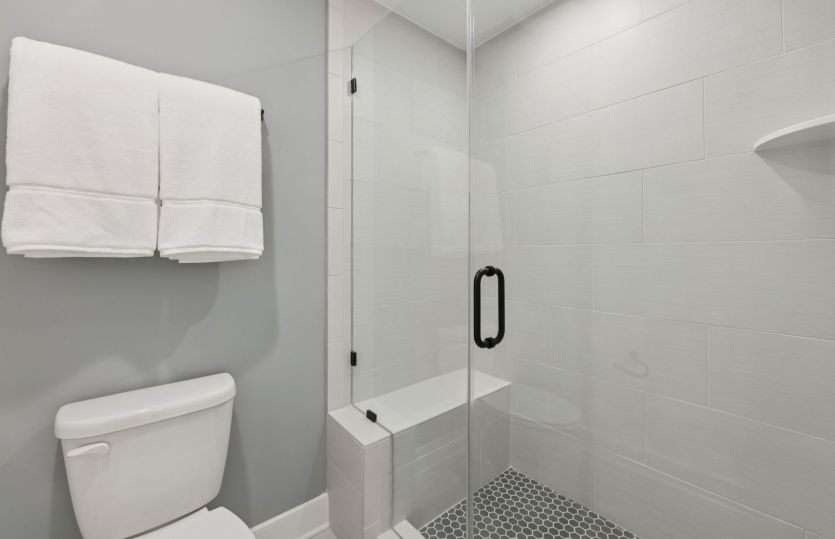 Hall Bath Features an Optional Frameless Shower with Seat