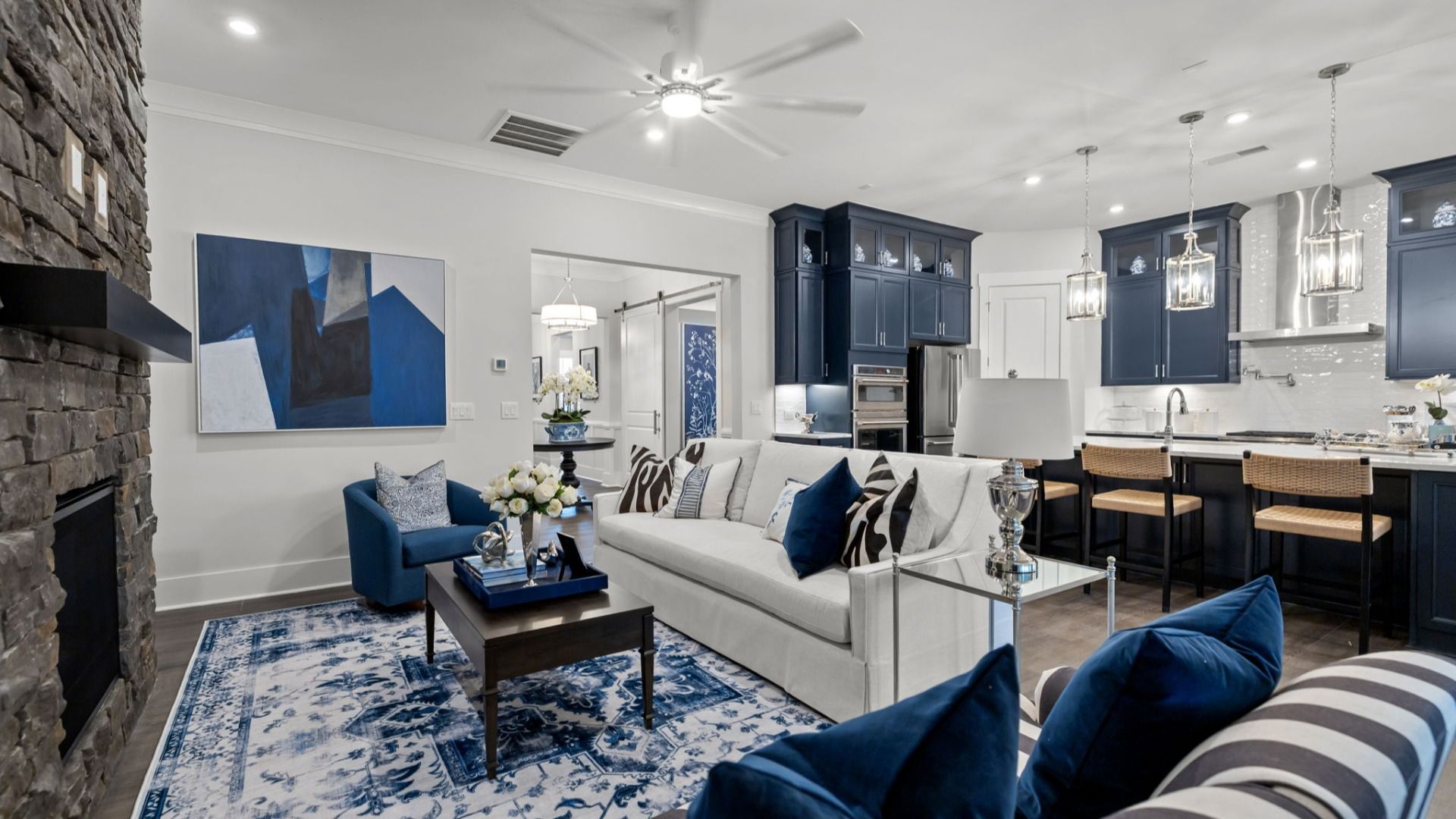 The Adventurer Plan by DBR Homes modern living area with large stone fireplace in Fort Mill, SC.