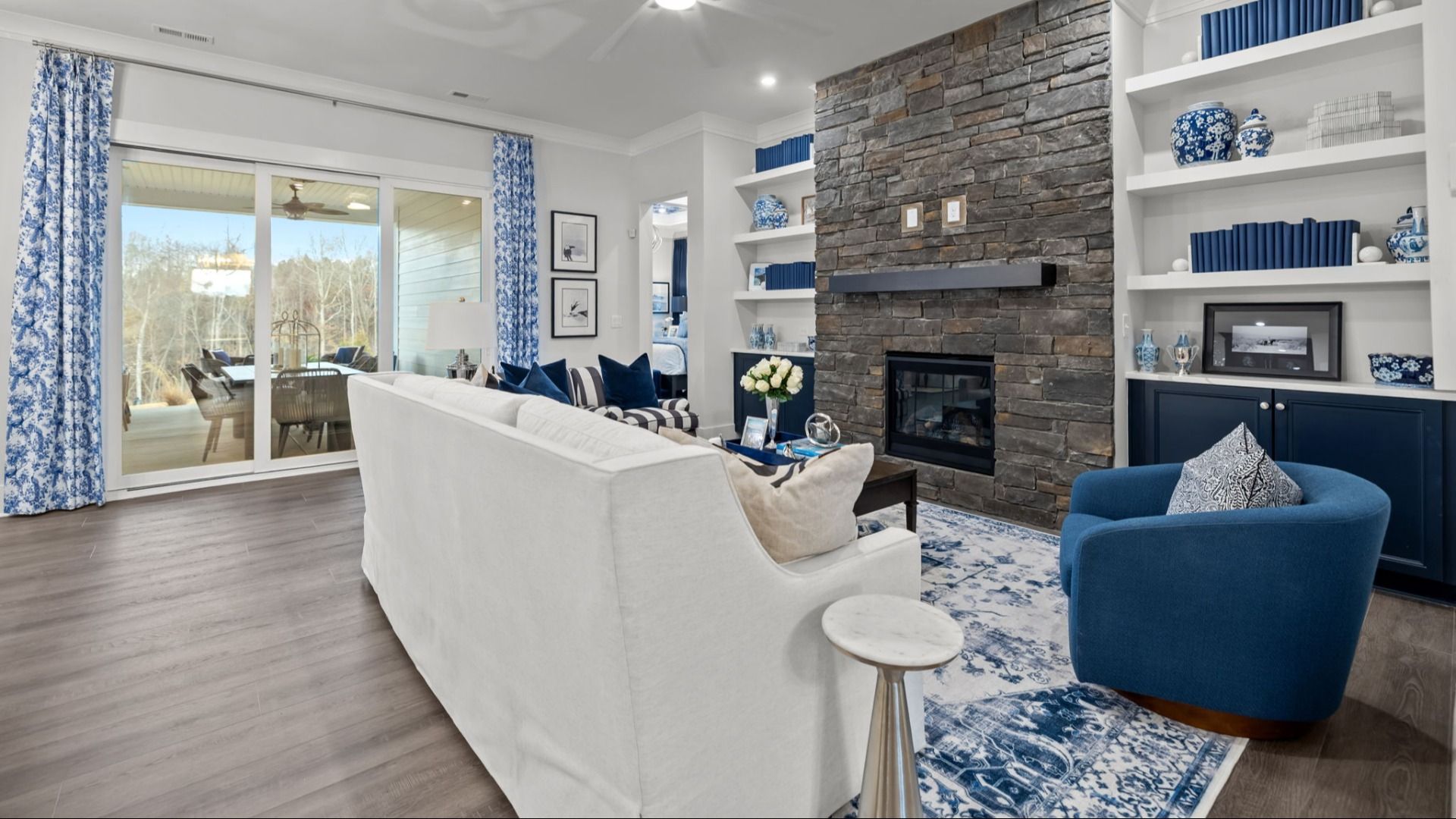 The Adventurer Plan by DBR Homes modern living area with large stone fireplace in Fort Mill, SC.