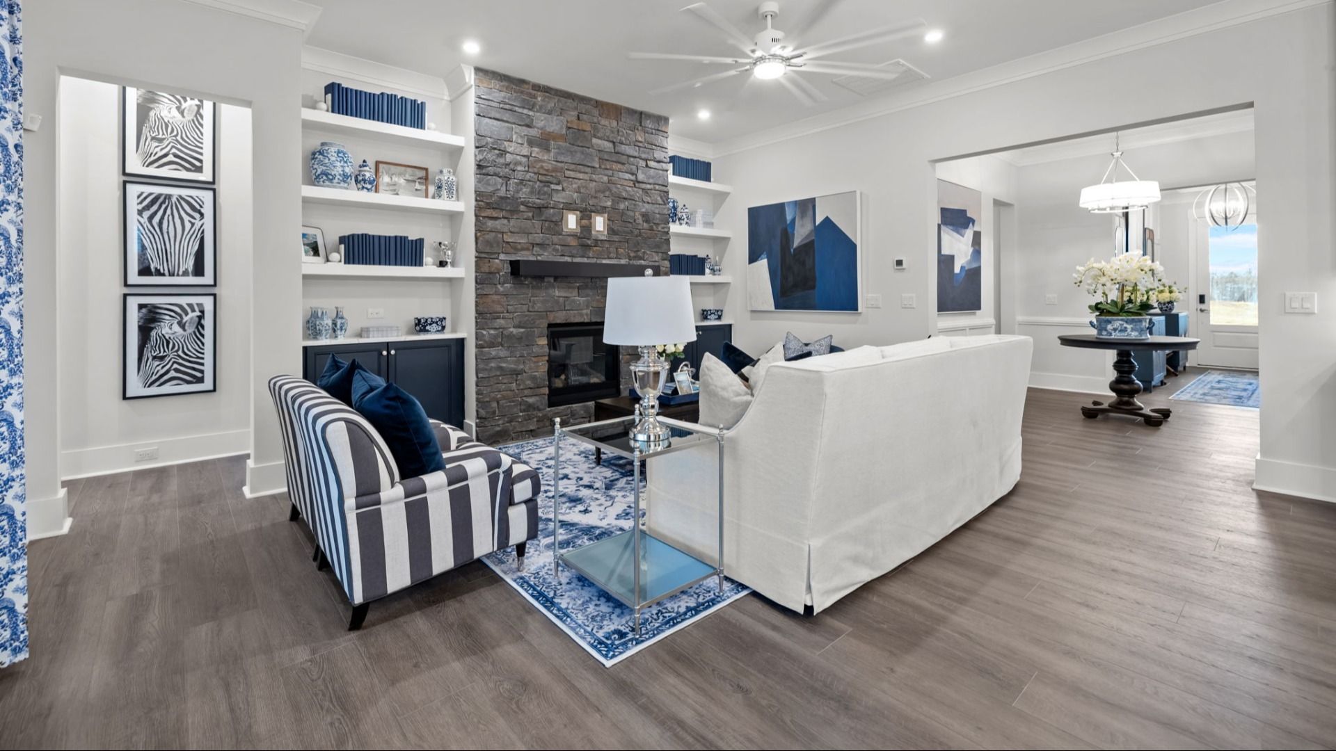 The Adventurer Plan by DBR Homes modern living area with large stone fireplace in Fort Mill, SC.