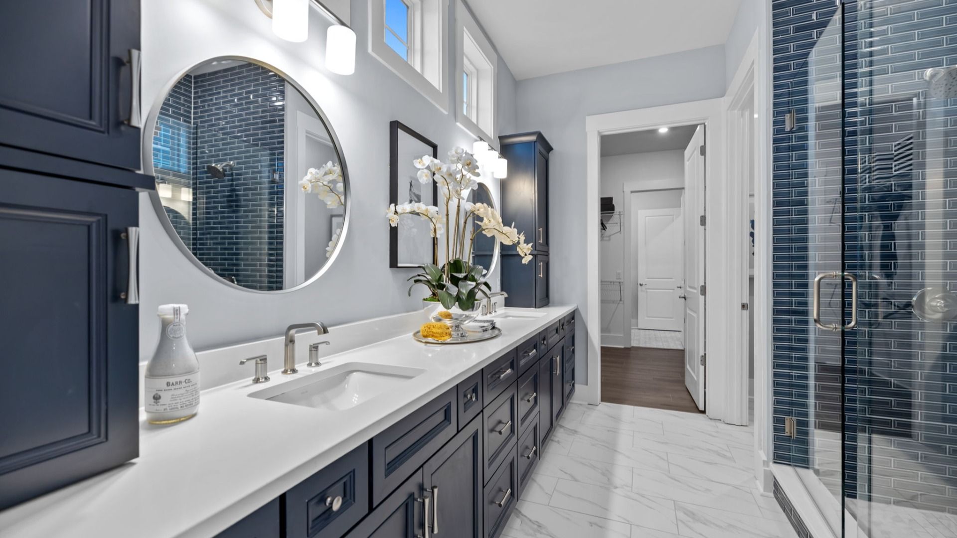 The Adventurer Plan with a modern bathroom featuring a glass-enclosed shower lined with rich navy blue tiles in Fort Mill, SC