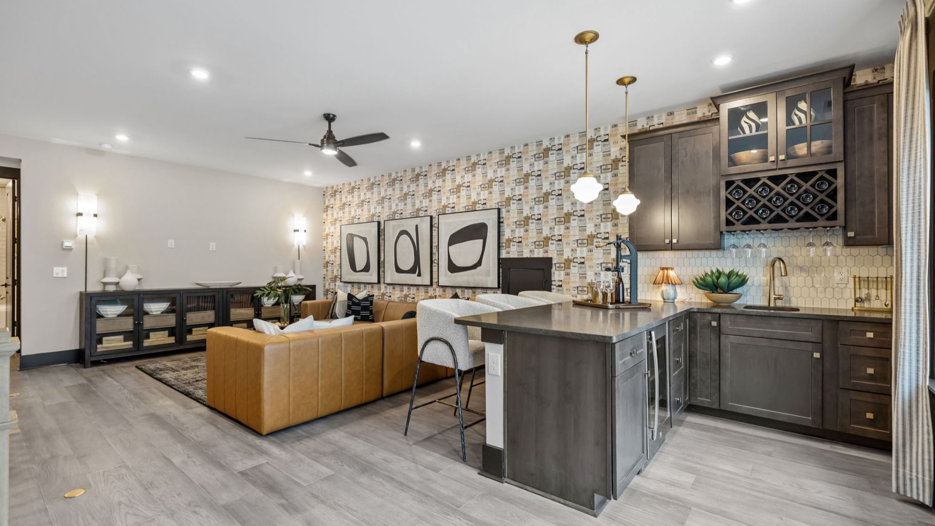 The Enthusiast Plan by DBR Homes an upstairs loft featuring a compact bar kitchen with sleek cabinetry in Fort Mill, SC