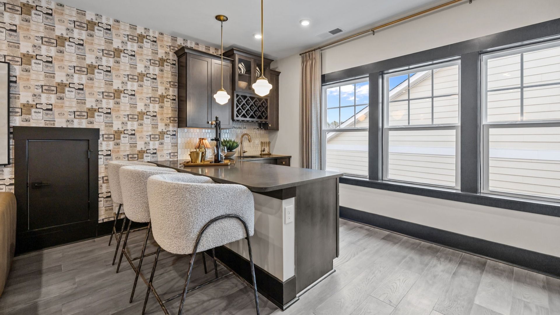 The Enthusiast Plan by DBR Homes upstairs loft featuring a compact bar kitchen with sleek cabinetry in Fort Mill, SC