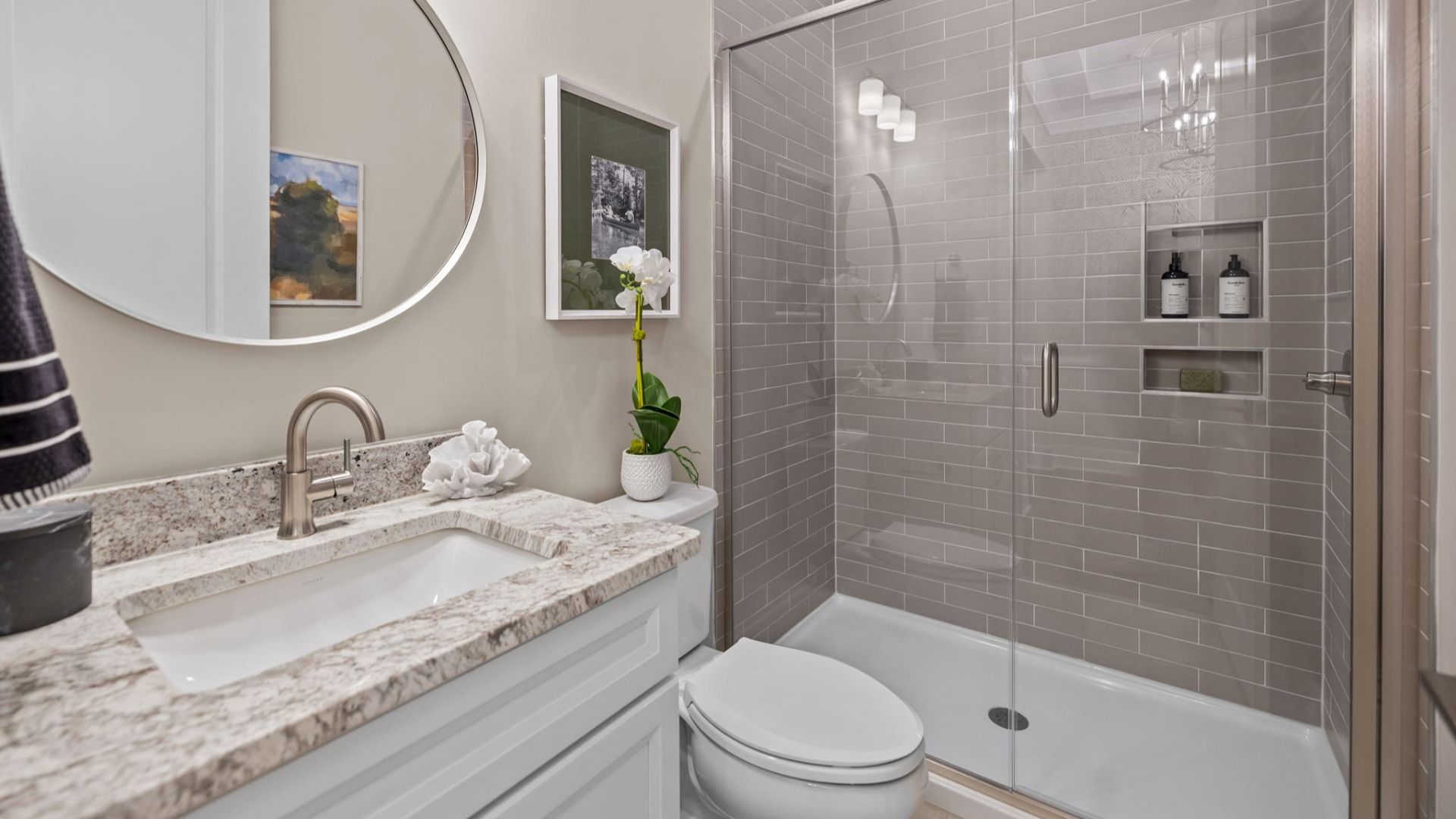 The Inspire Plan with a modern bathroom featuring a glass-enclosed shower lined with rich grey tiles in Fort Mill, SC