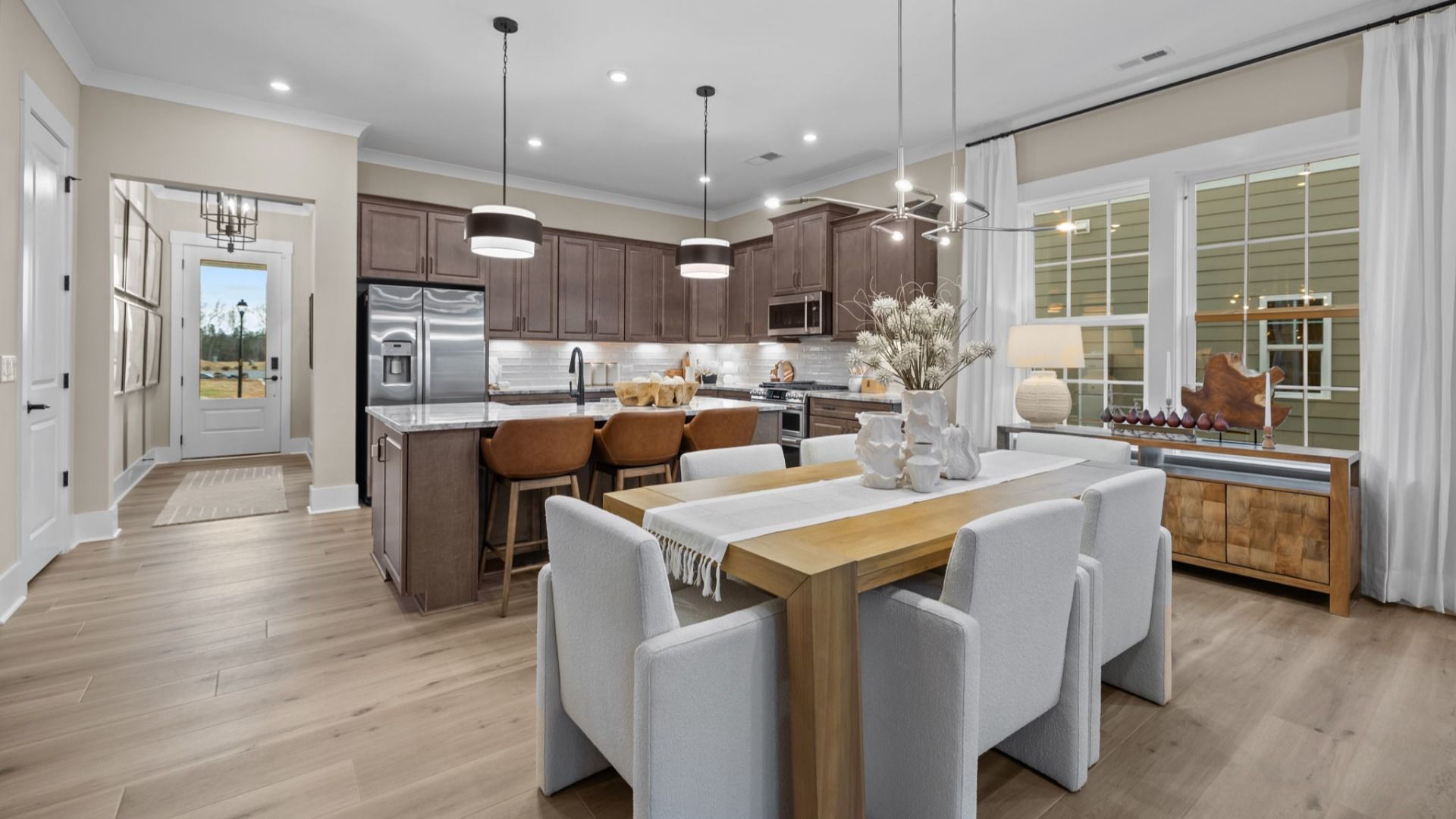 The Virtuoso Plan by DBR Homes kitchen and dining area with modern cabinets and black features in Fort Mill, SC.