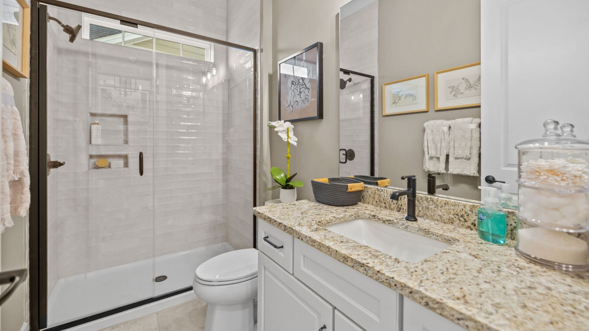 The Virtuoso Plan by DBR Homes with a modern bathroom featuring a glass-enclosed shower in Fort Mill, SC
