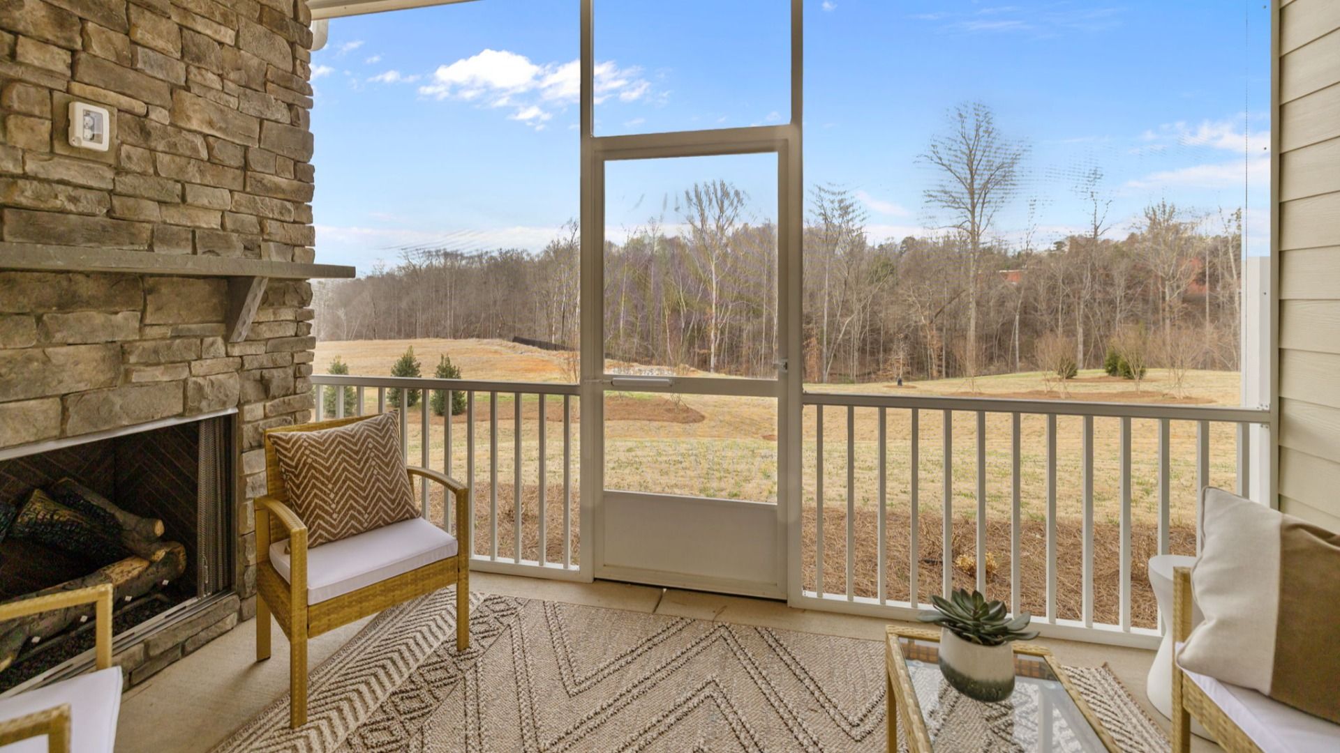 The Virtuoso Plan by DBR Homes with a cozy rear porch and stone fireplace in Fort Mill, SC