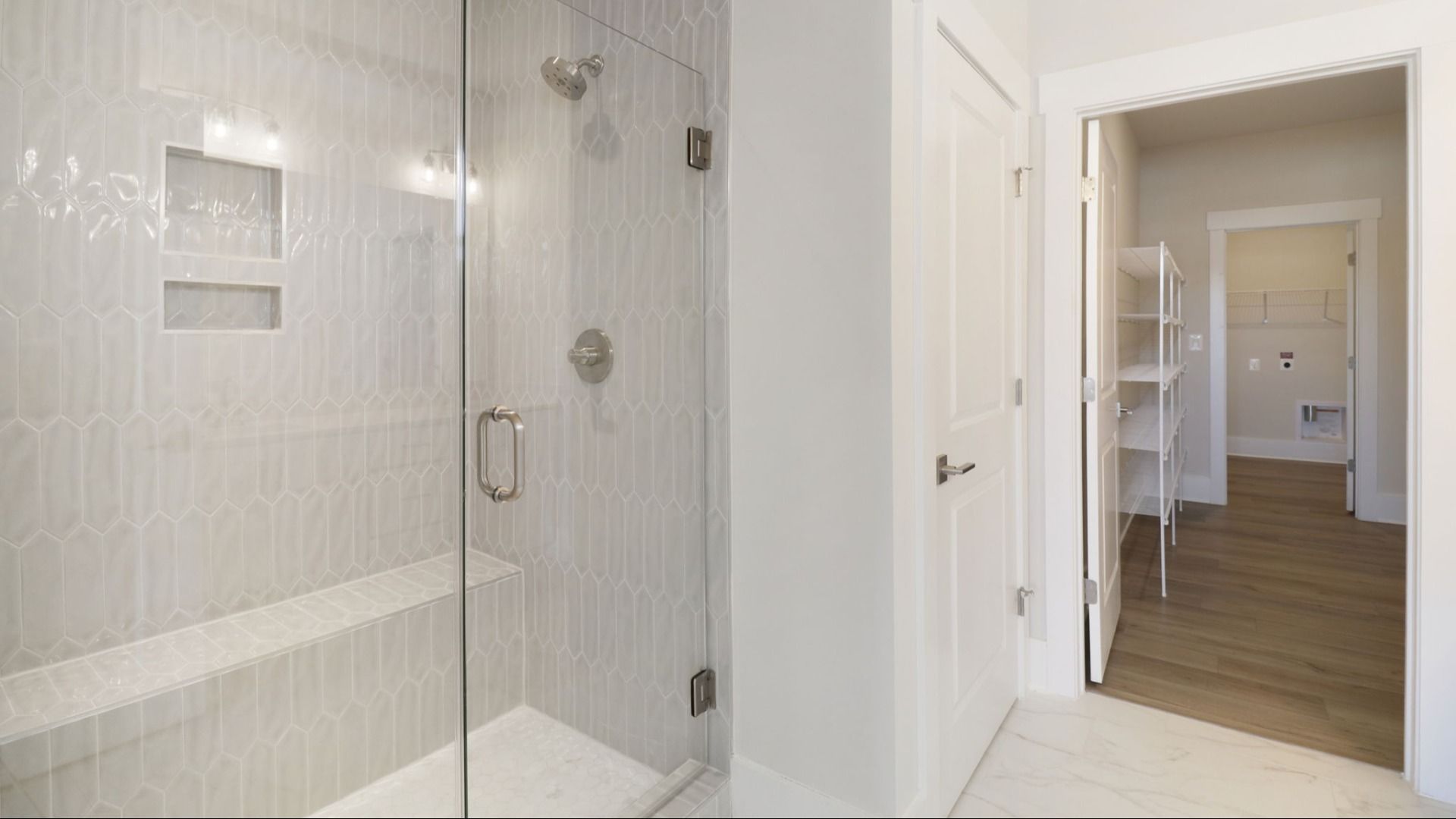 The Awaken Plan by DRB Elevate in Brook Run, Fort Mill SC - Primary bathroom connecting to the walk-in closet & laundry room