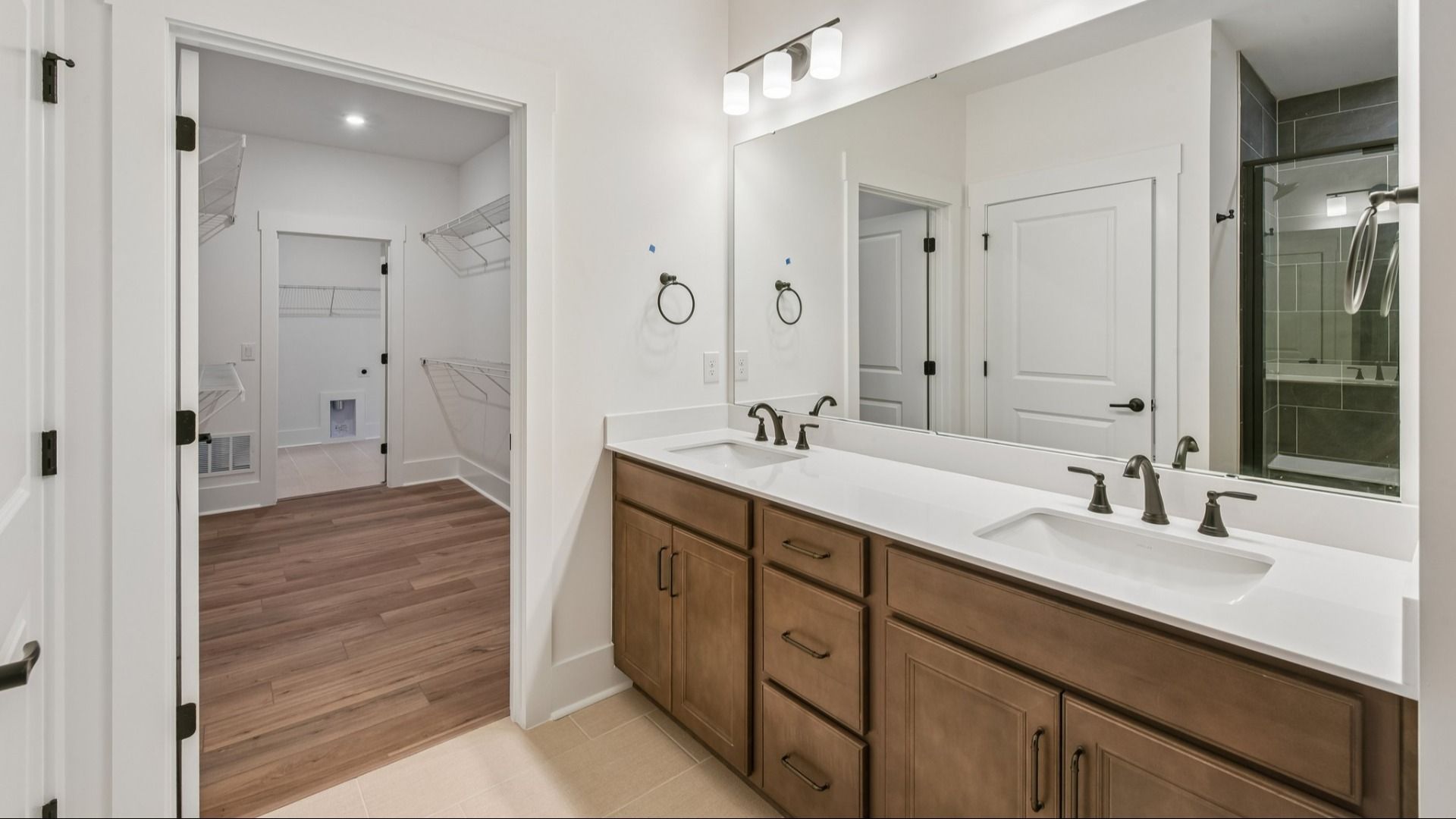 The Awaken Plan by DRB Elevate in Brook Run, Fort Mill SC - Primary bathroom connected to walk-in closet and laundry room