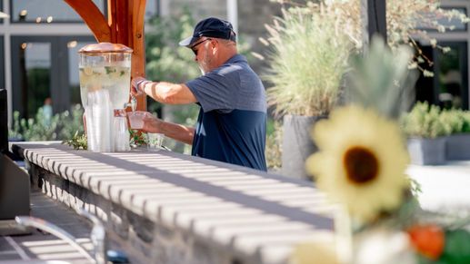 An Amblebrook resident enjoys refreshments on the Great Lawn in Gettysburg, PA, highlighting the 55+ community lifestyle.
