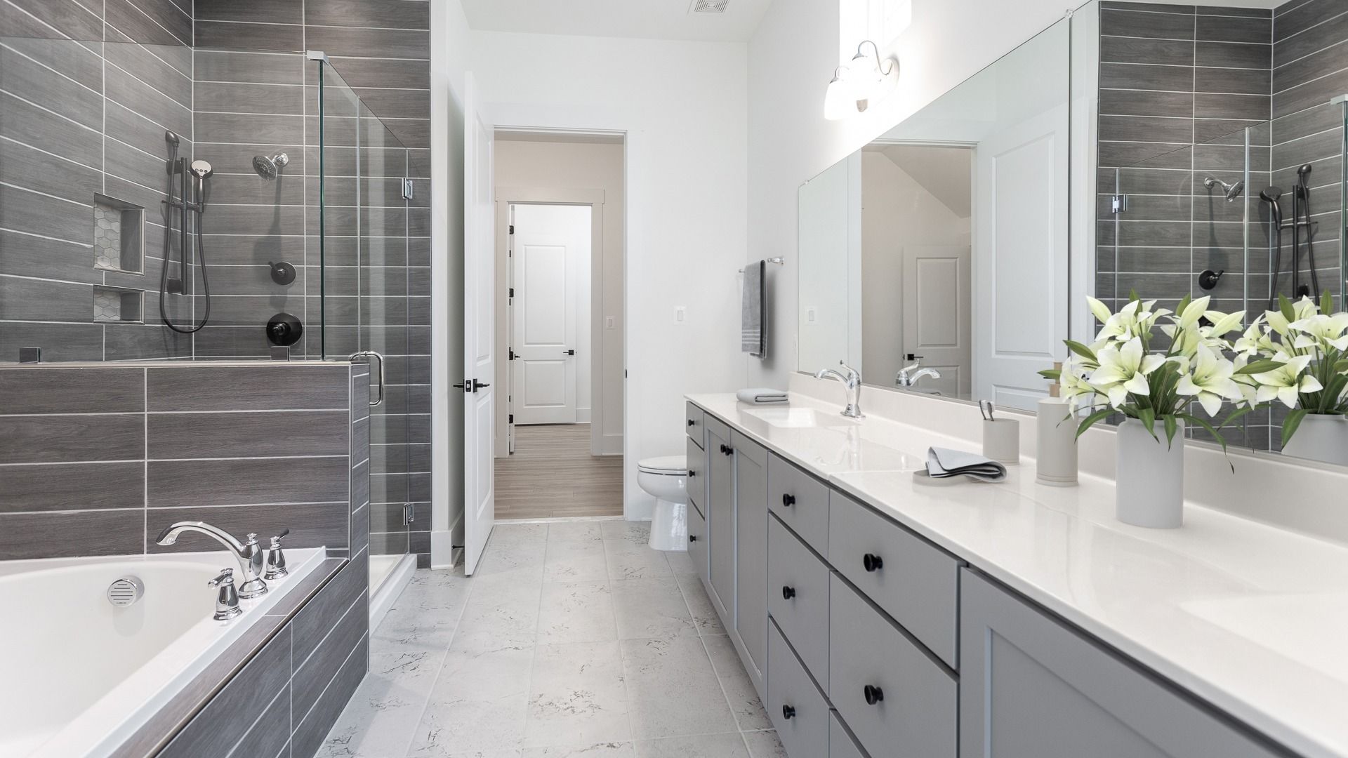 The owner’s bathroom in the DRB Elevate Adventurer floor plan offers a sleek, spacious full bath.