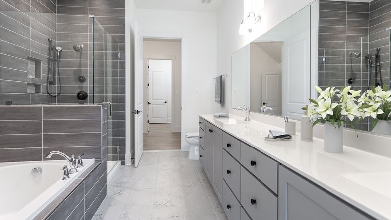 The owner’s bathroom in the DRB Elevate Adventurer floor plan offers a sleek, spacious full bath.
