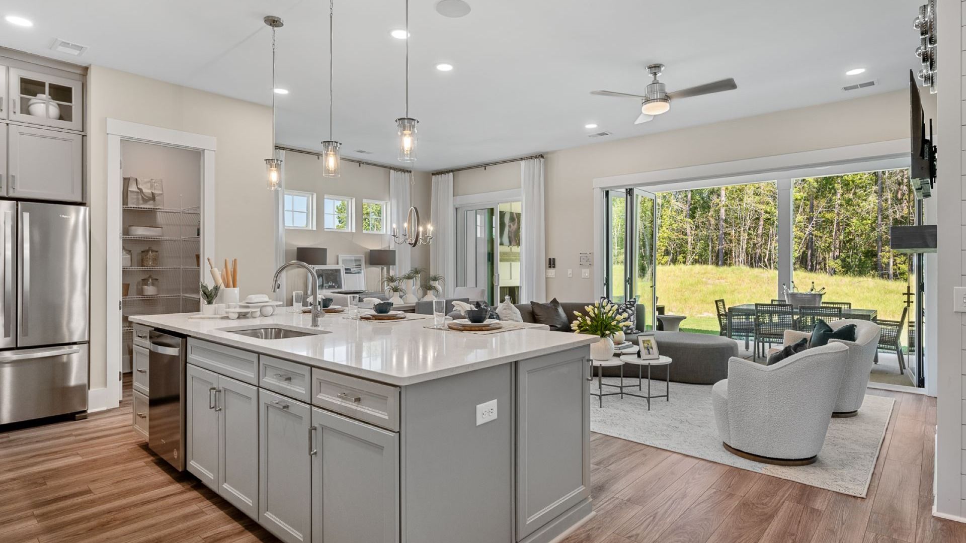 Living room and kitchen of the Enthusiast floorplan at Summerwind Crossing at Lakes of Cane Bay
