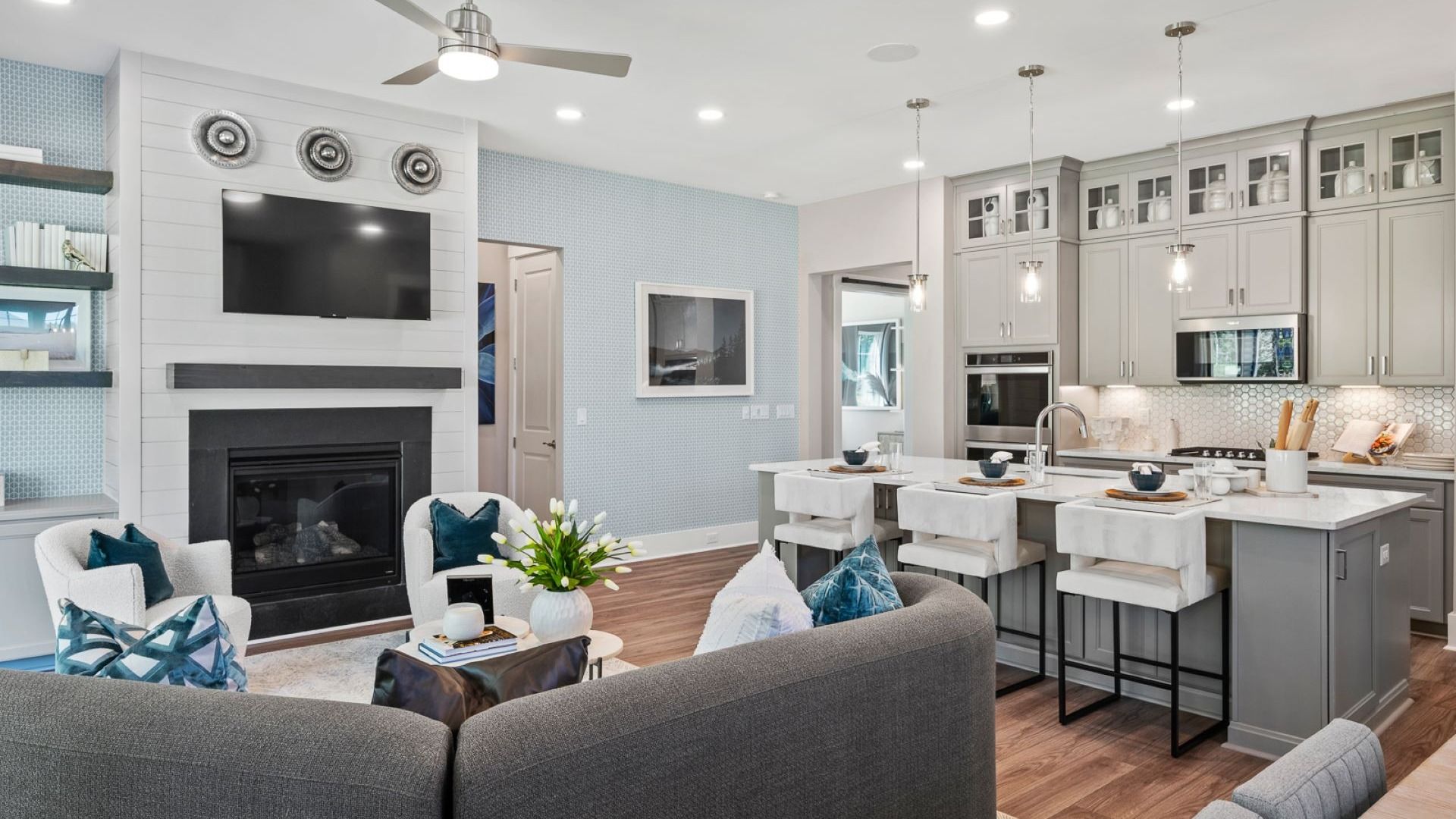 Living room of the Enthusiast floorplan at Summerwind Crossing at Lakes of Cane Bay features an electric fireplace