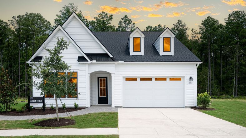 Adventurer model in Lakes of Cane Bay community Summerwind Crossing features an amazing white wood exterior with black trim