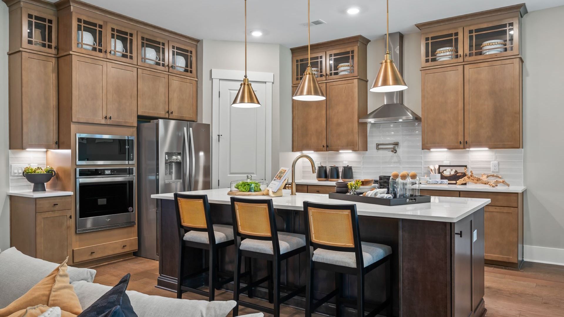 Chefs kitchen adventurer model in Summerwind Crossing at Lakes of Cane Bay features amazing light fixtures and mixed metals
