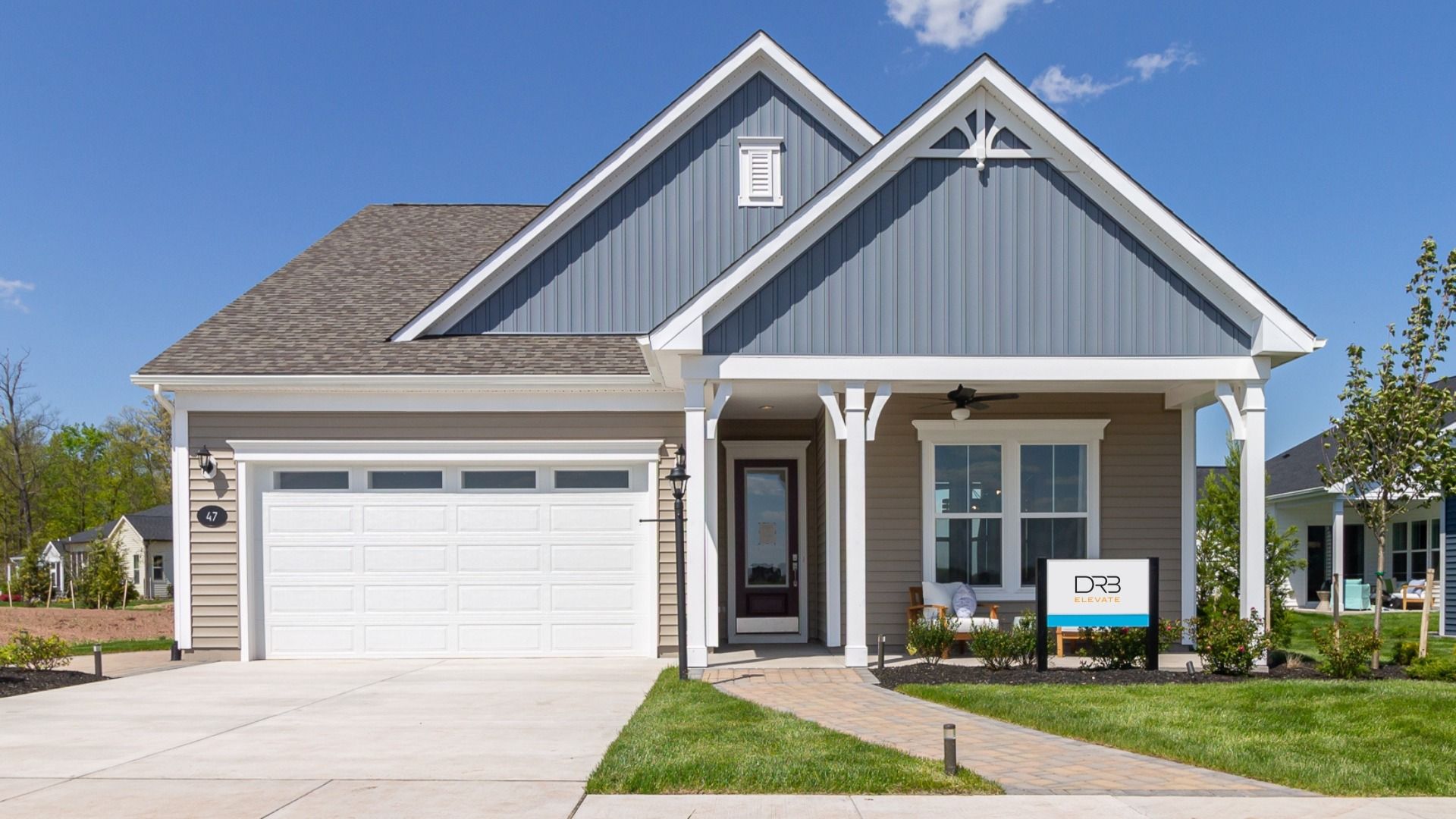 The front exterior of the Virtuoso floor plan by DRB Elevate features a charming, tasteful design.