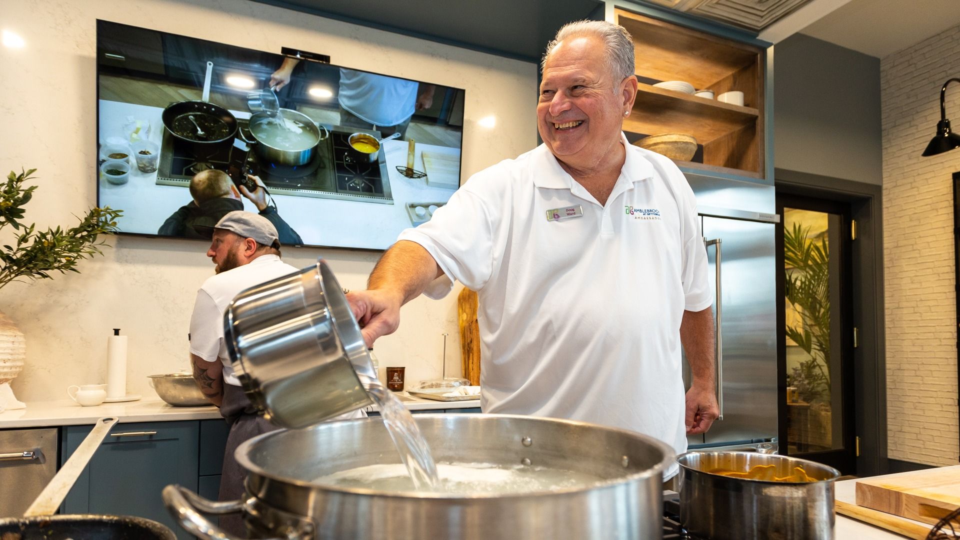 A chef prepares a meal in the Amblebrook Clubhouse kitchen, showcasing the vibrant 55+ lifestyle in Gettysburg, PA.