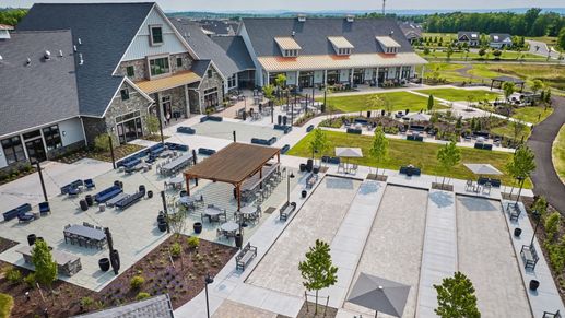 Bird’s-eye view of the Amblebrook Clubhouse and Great Lawn with lush greenery and gathering spaces.