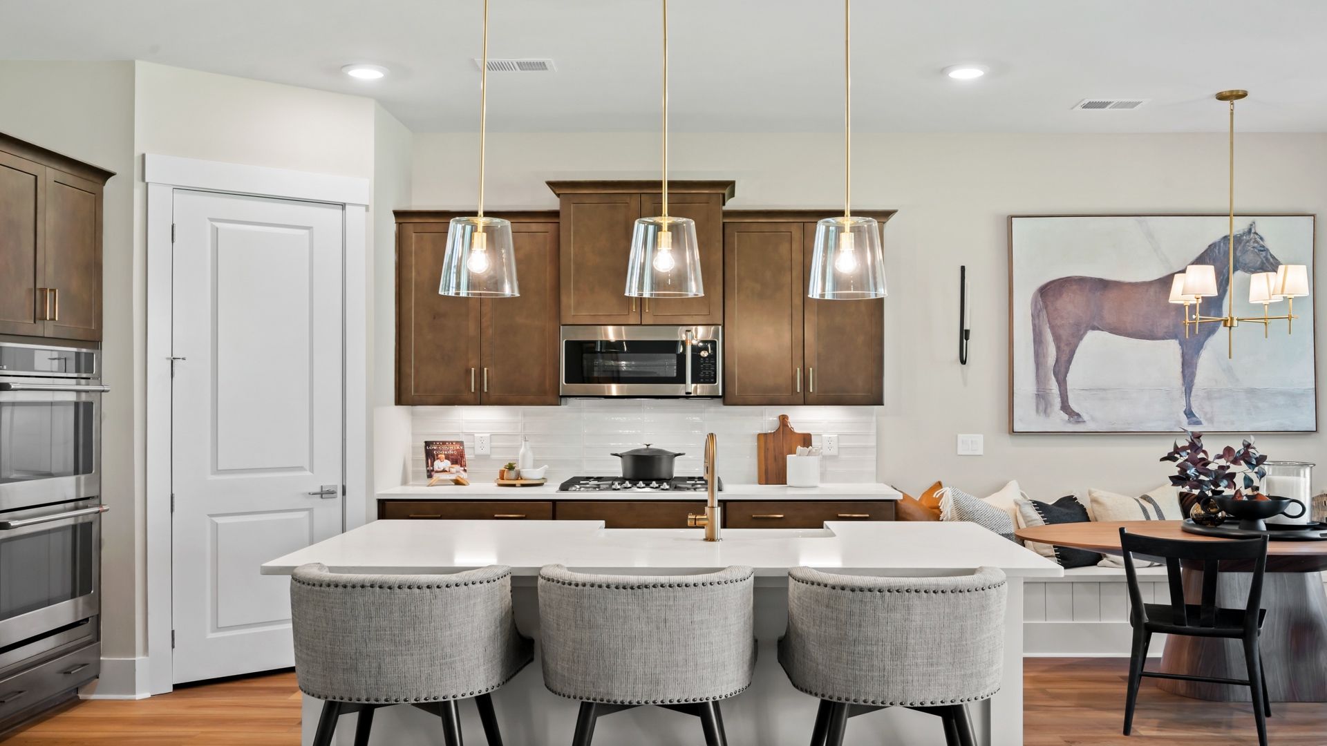 The Traveler kitchen features a spacious island, quartz countertops, and stylish 42" cabinets.