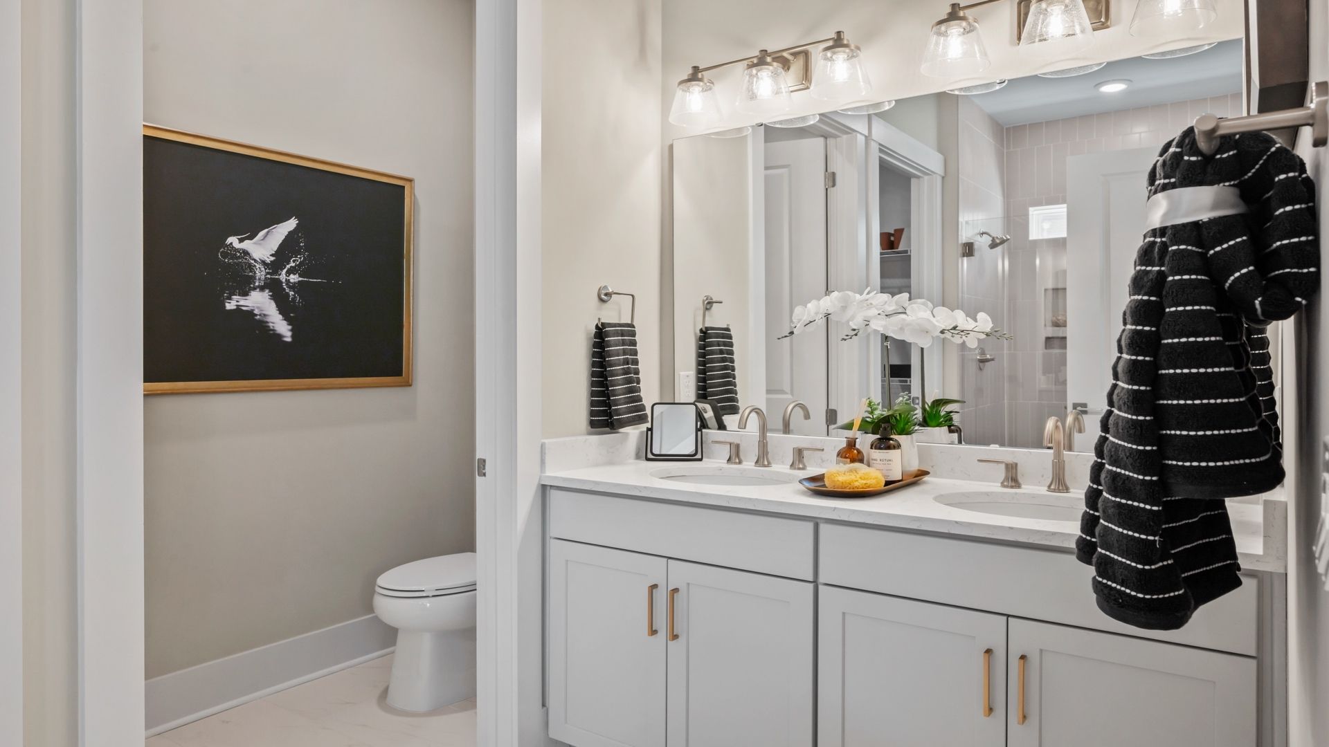 Primary bath in the Traveler model, featuring dual sinks and quartz finishes