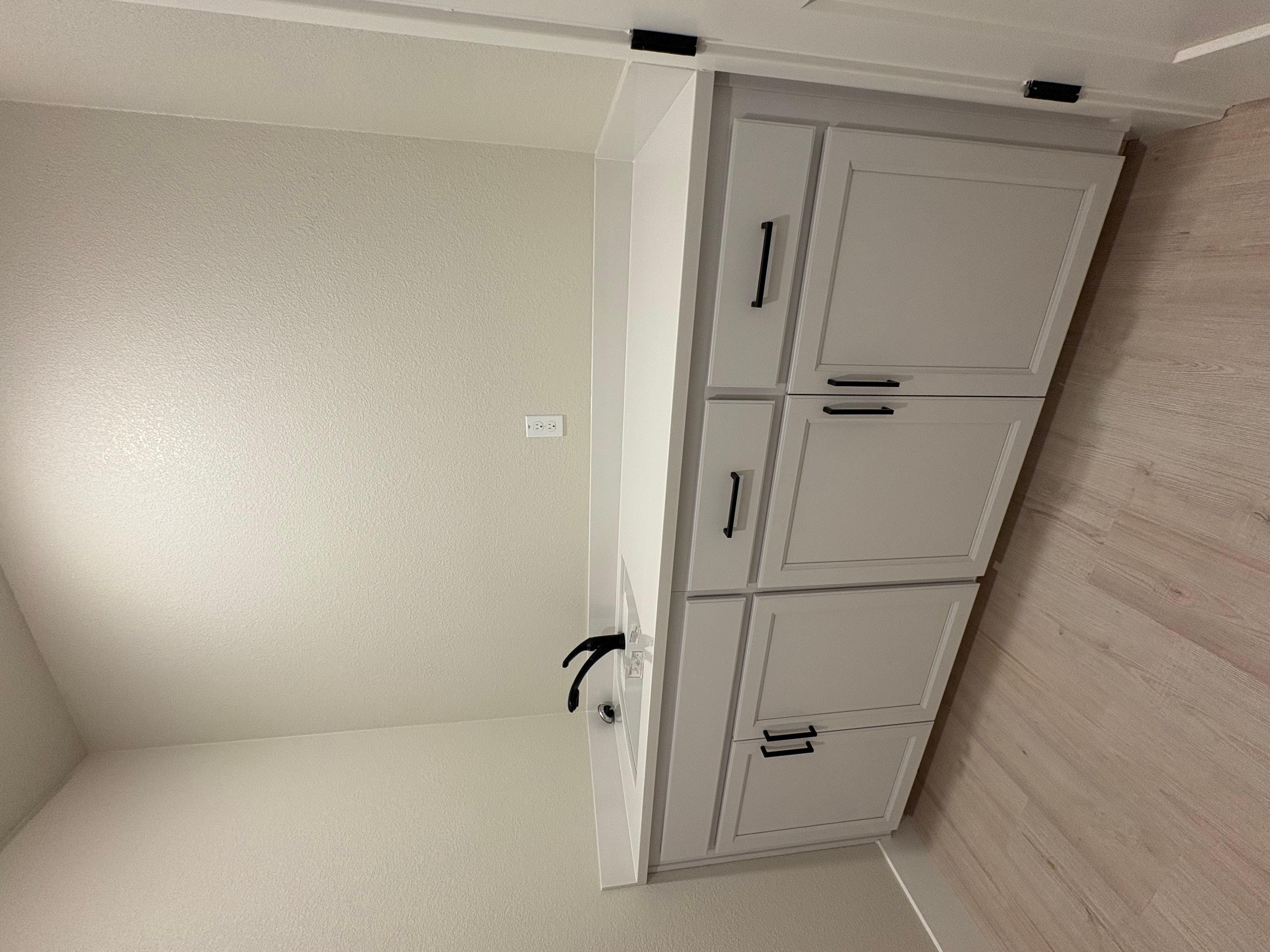 Laundry room with sink and lower cabinets