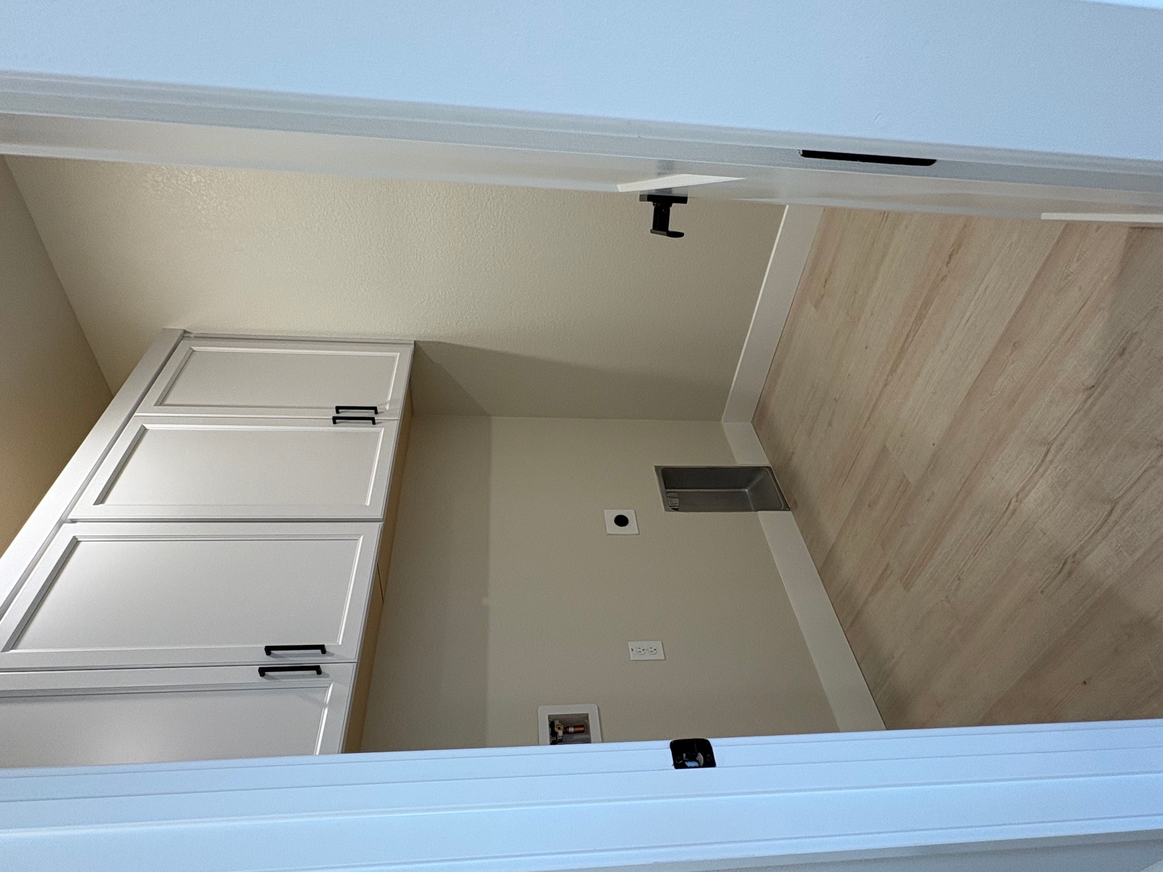 Laundry room with upper cabinets