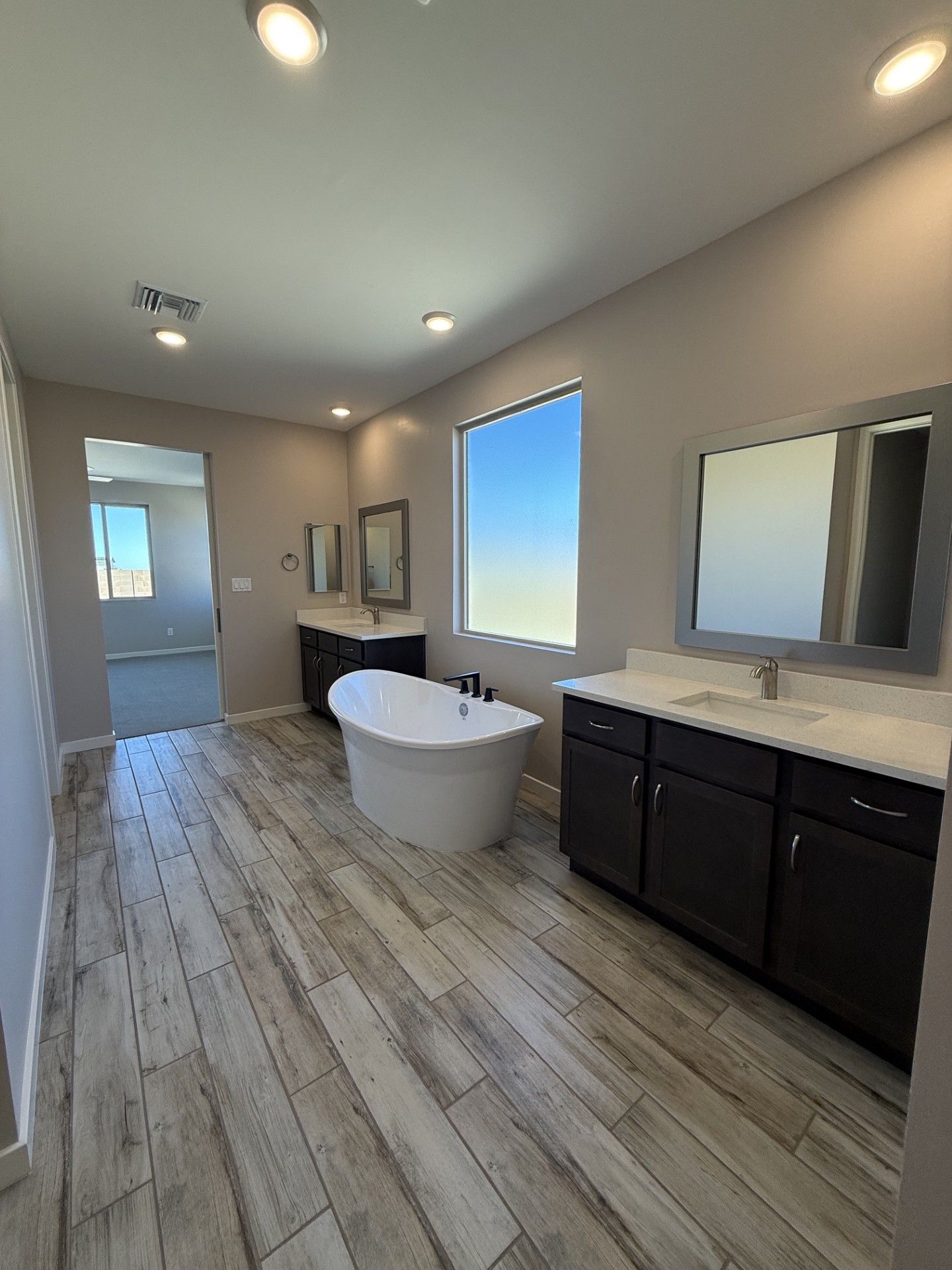 Primary Bath with Freestanding Tub and Dual Vanities