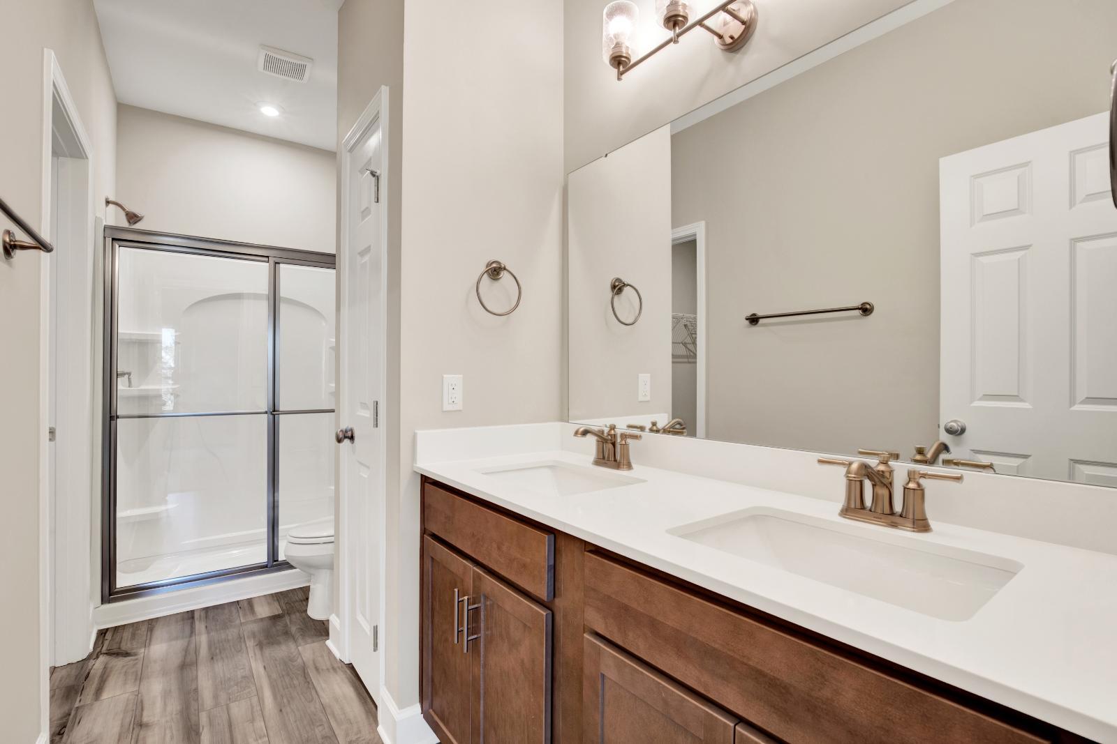 Owner's Bathroom with Double Sinks, Marble Tops, & Linen Closet