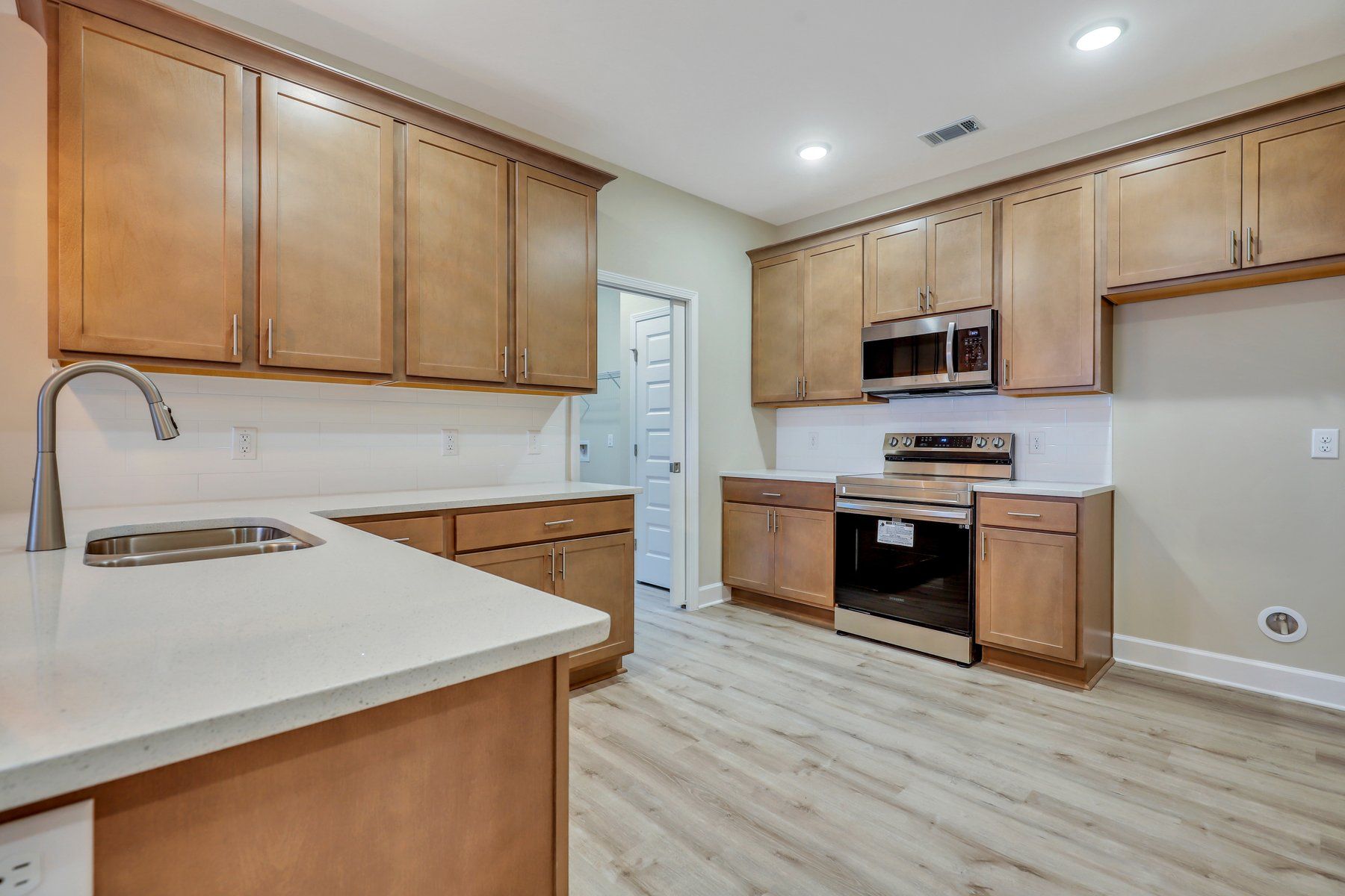 Hatteras – Kitchen View into Optional Laundry Room with Storage Closet