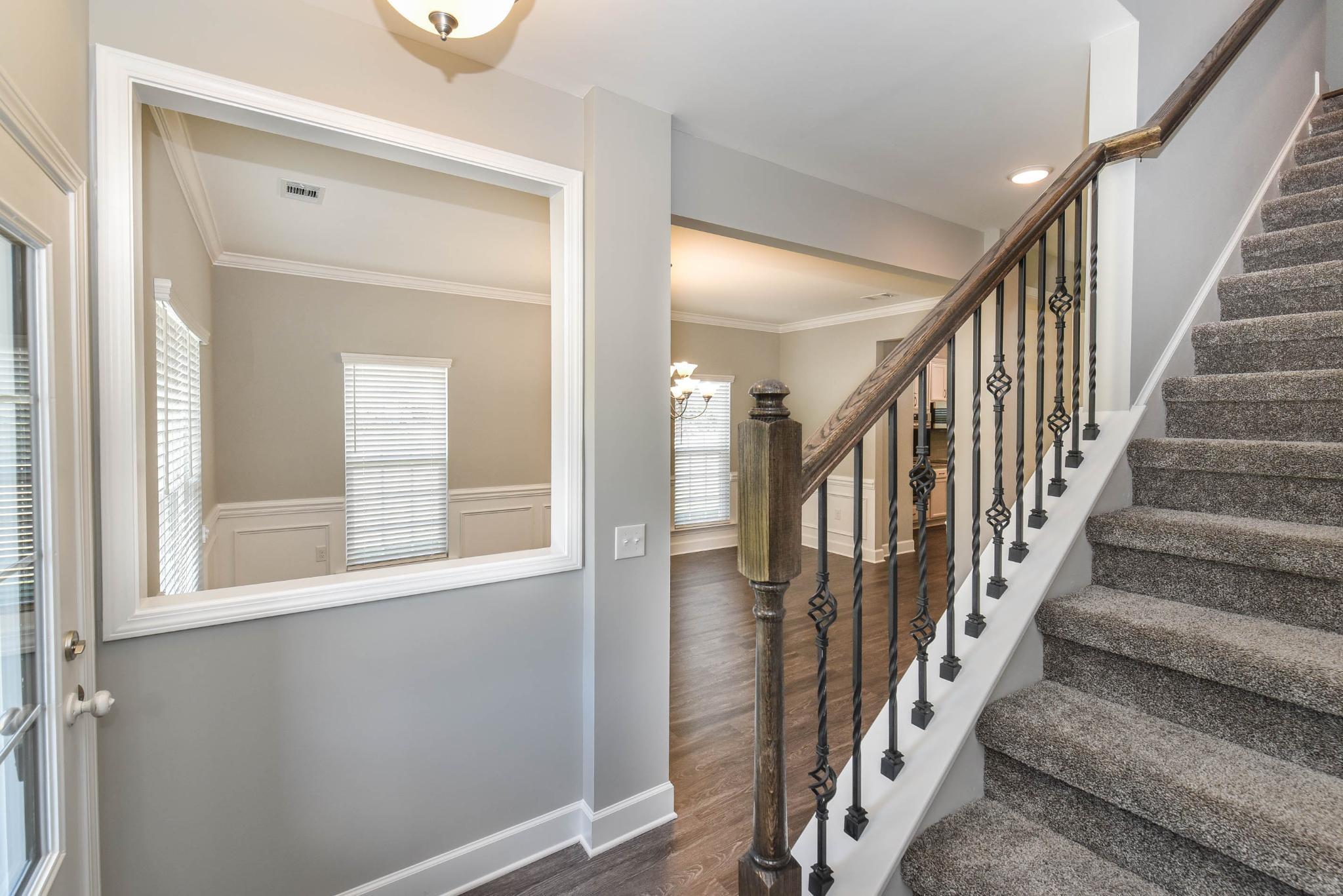 Greybeard - Carpeted stairs with oak railing and iron balusters | Ernest Homes