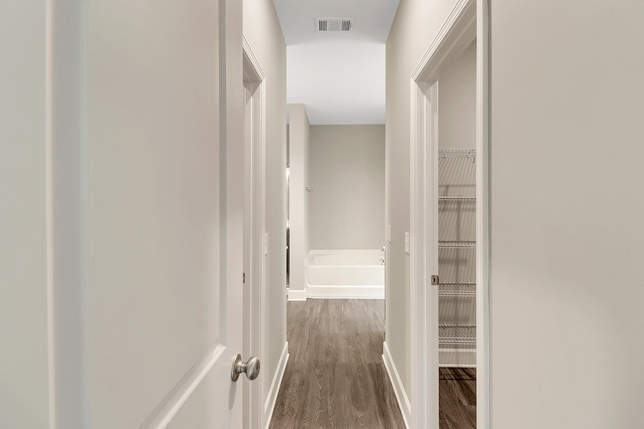 Harbor – Entry to Primary Bathroom with Walk-in Closets on either Side | Ernest Homes