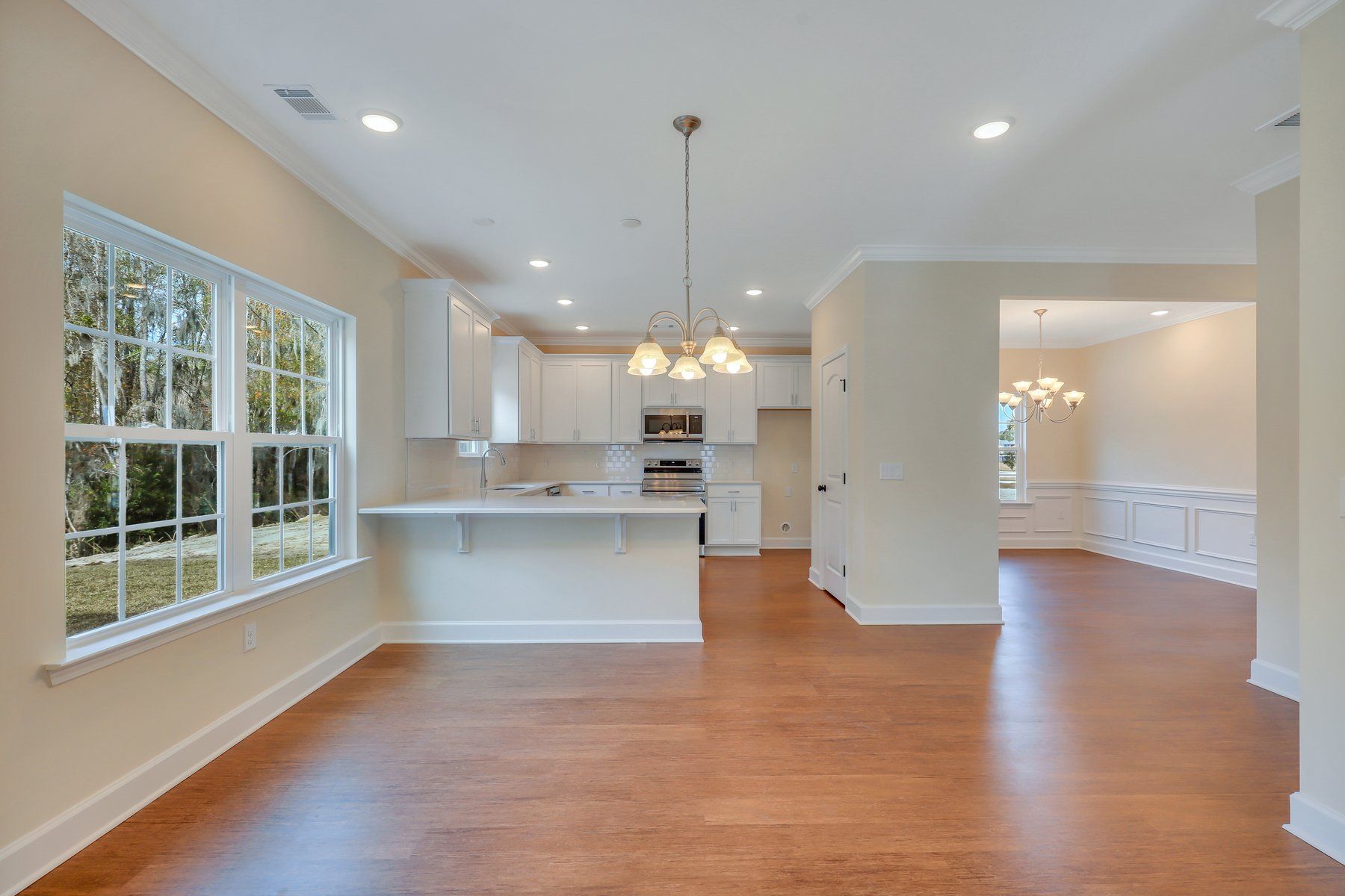 View from family room to breakfast area, dining room, and kitchen - Nantucket plan built by Ernest
