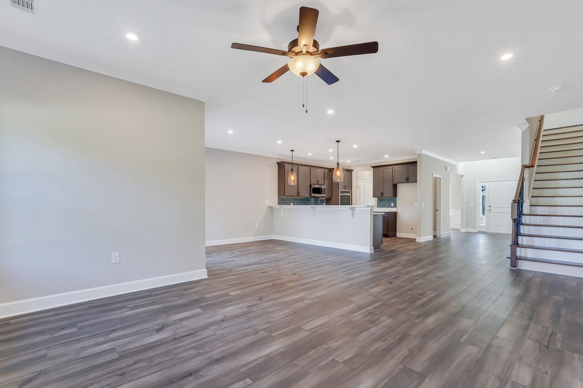 Kingston - Family Room with view into Kitchen, Foyer, and Stairway  | Ernest Homes