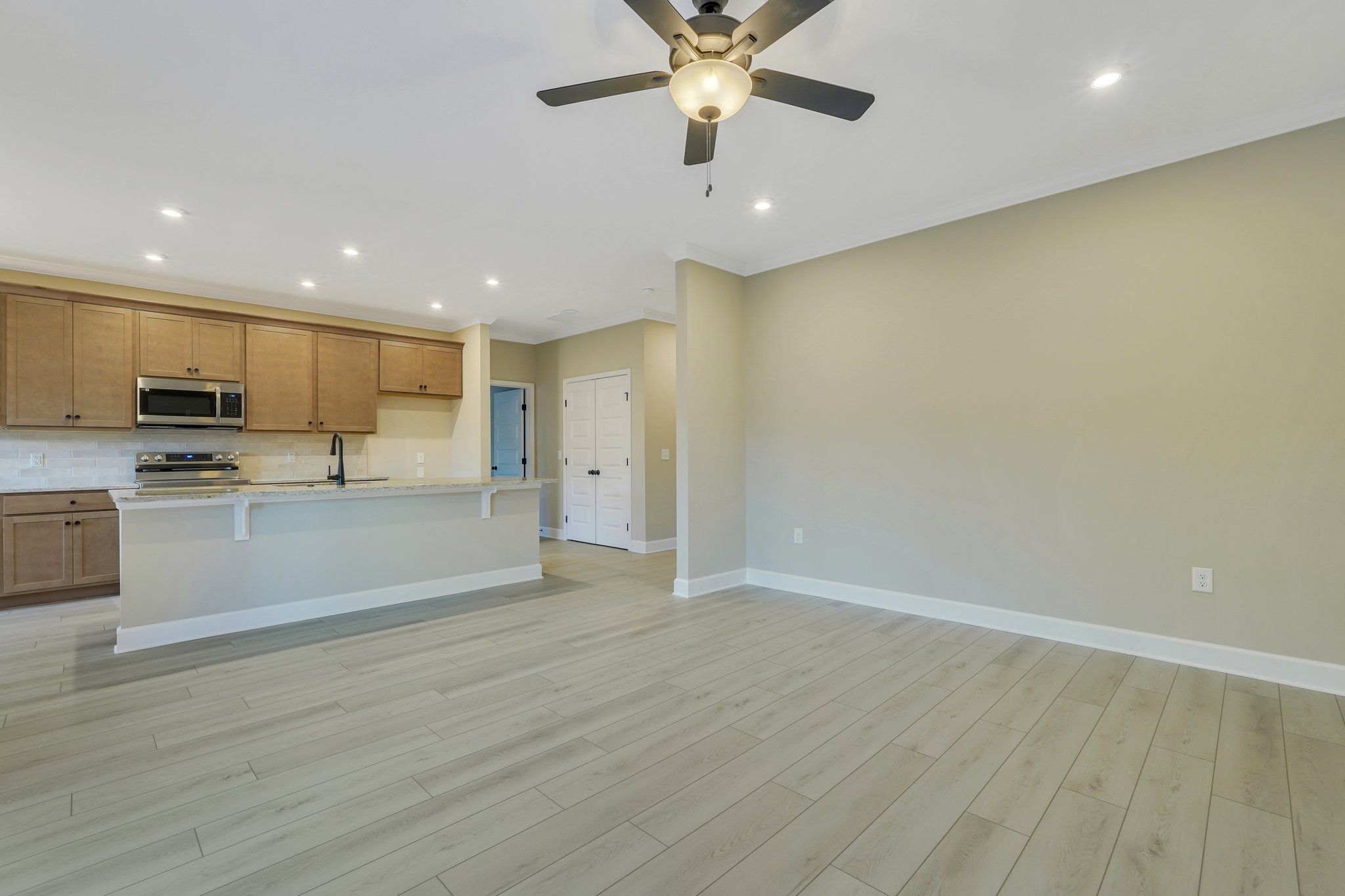 Harbor II Kitchen with Wood Cabinets and Open Living Space