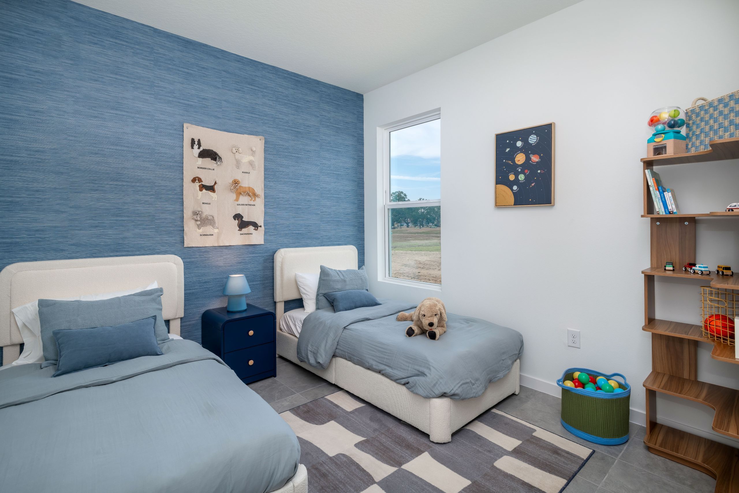 A comfortable secondary bedroom with natural light and a versatile layout ideal for guests, kids, or a home office.