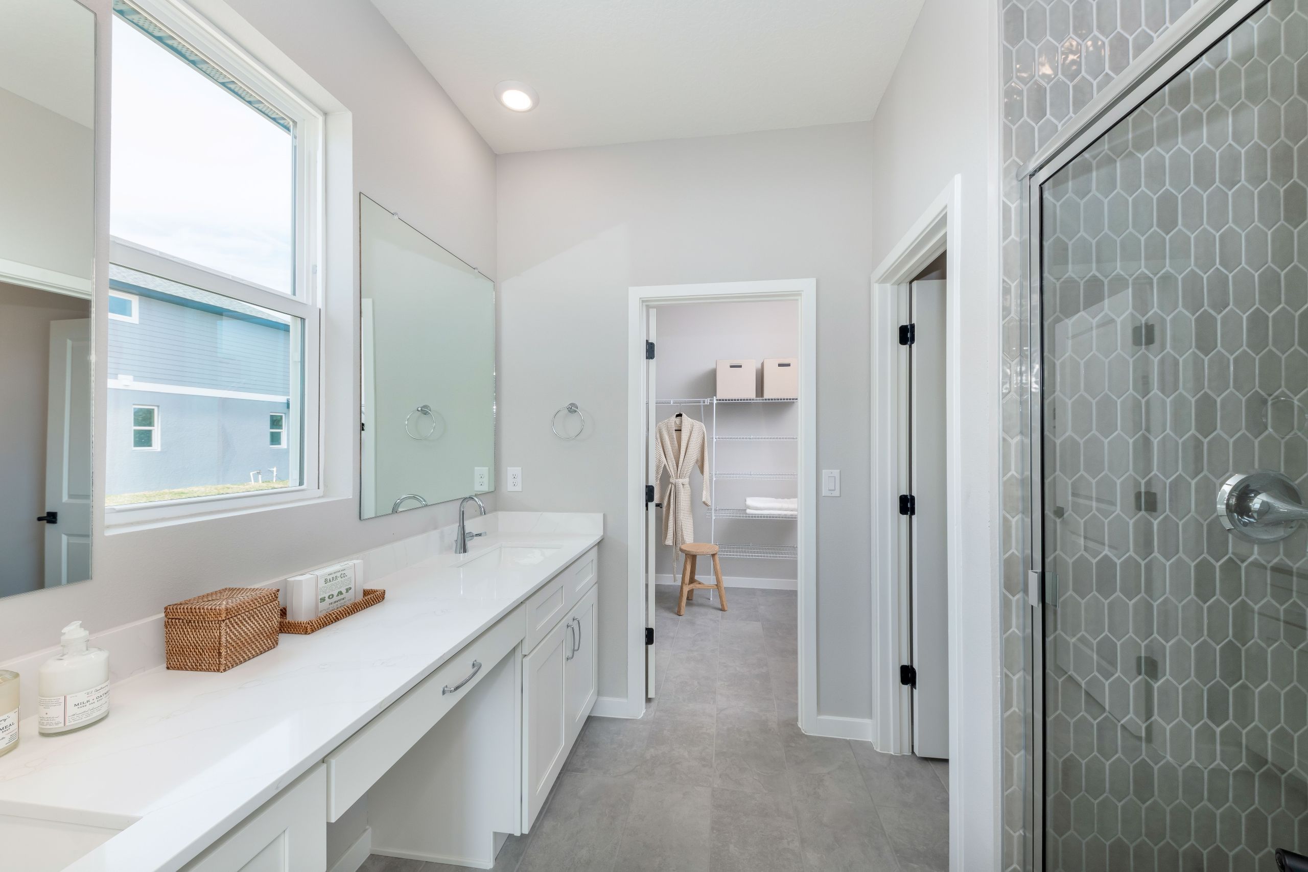 A luxurious primary bathroom with dual sinks, a spacious shower, and refined finishes that elevate everyday comfort.