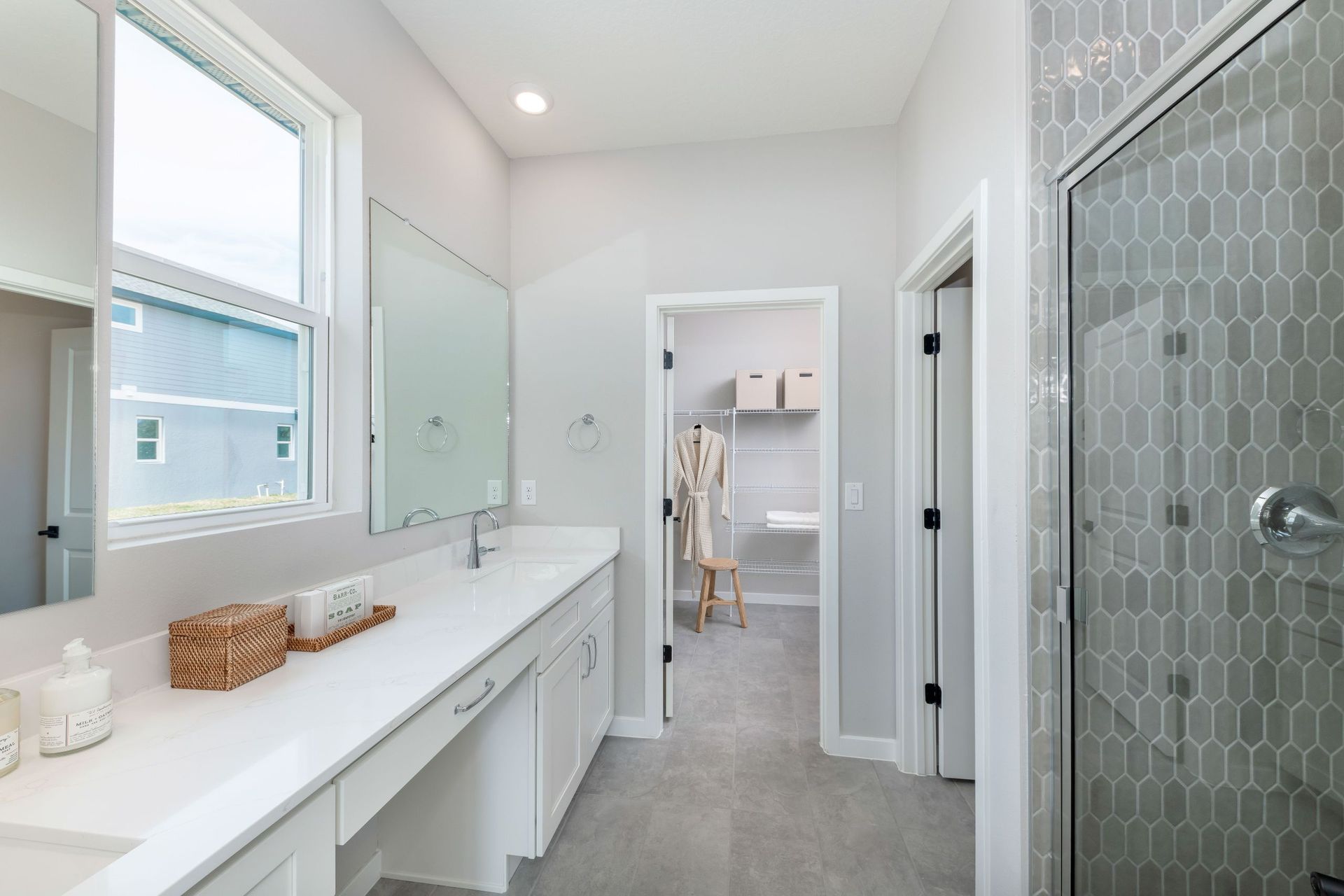 A luxurious primary bathroom with dual sinks, a spacious shower, and refined finishes that elevate everyday comfort.