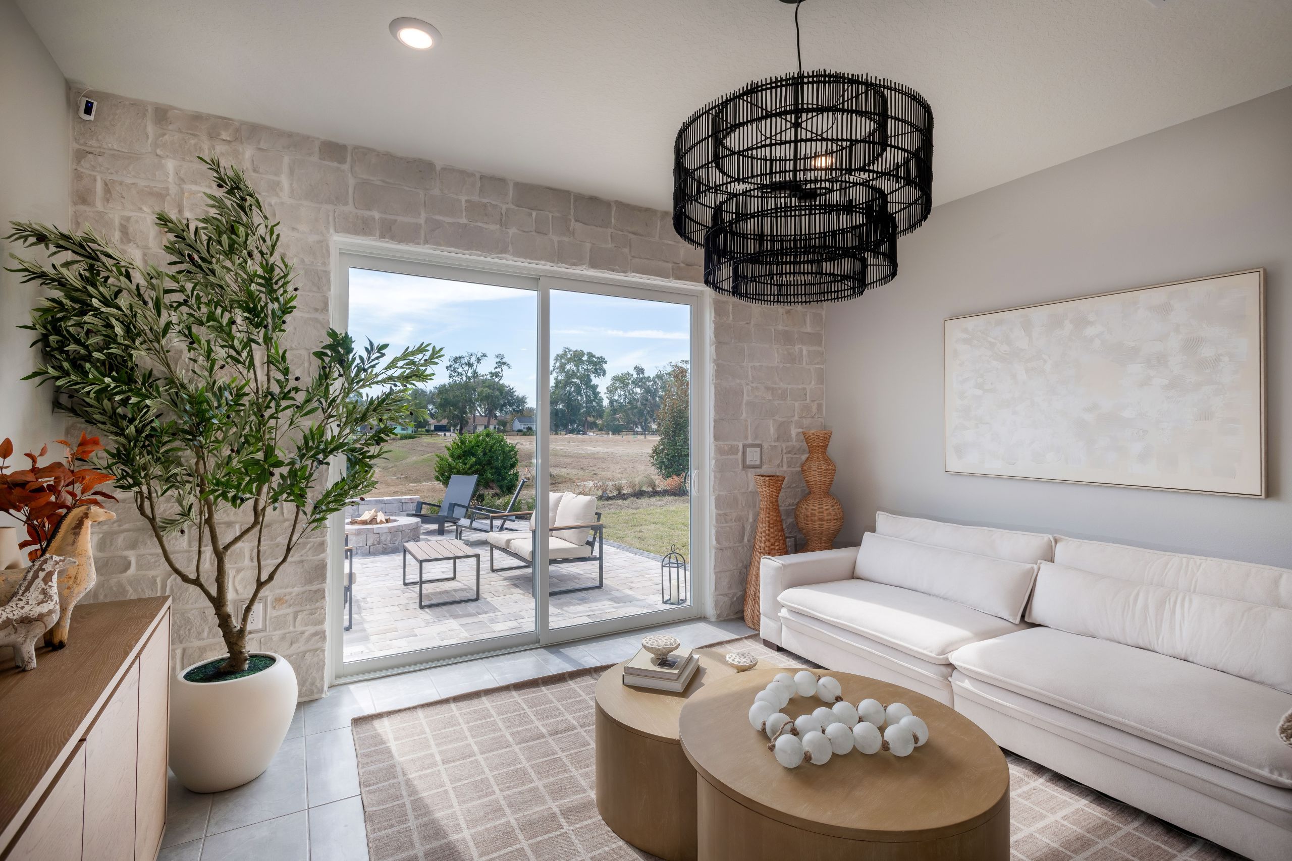 A spacious great room with abundant natural light and open views to the kitchen and dining areas, creating a warm central gathering space.