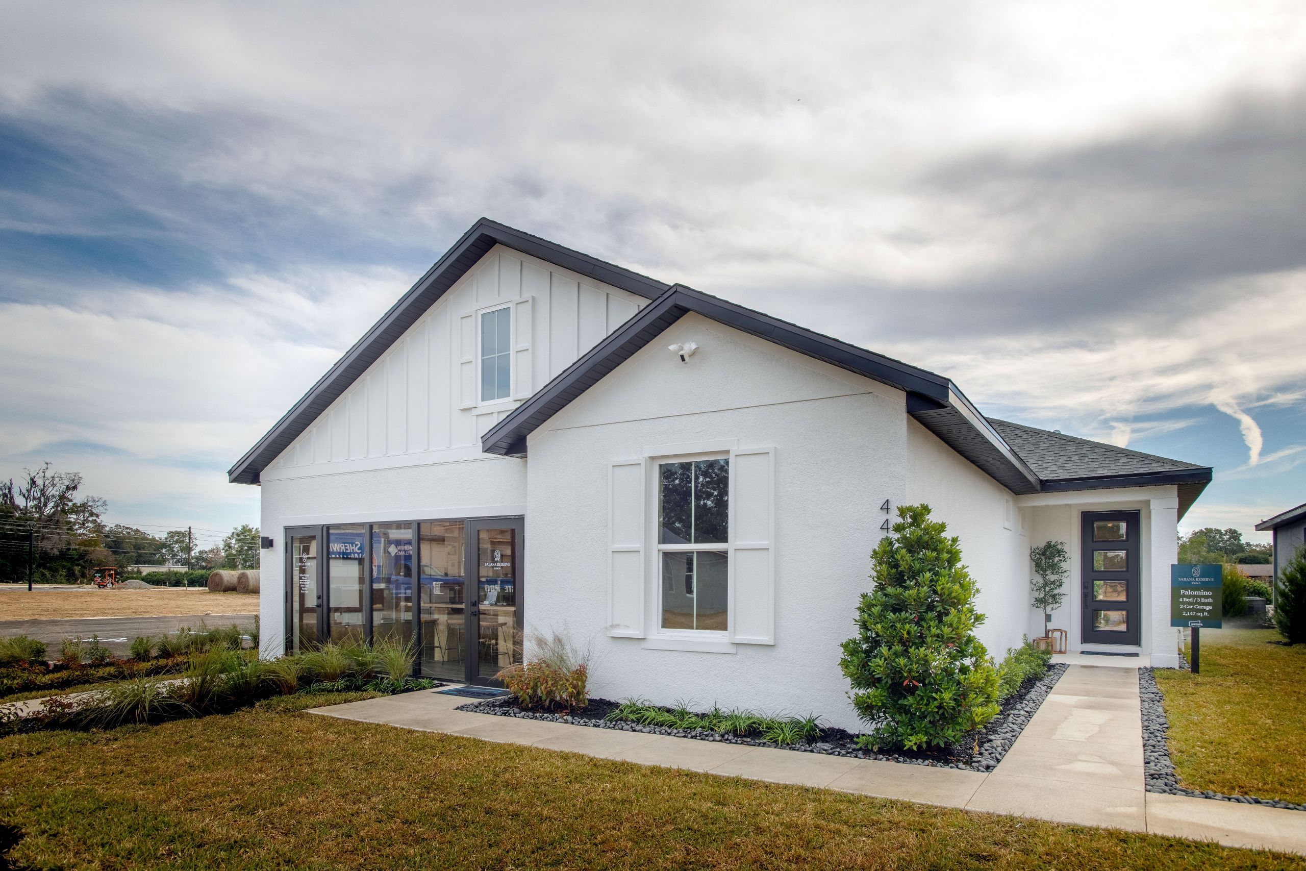 A welcoming streetscape view of the Palomino, highlighting its modern farmhouse style, thoughtfully landscaped front yard, and warm community setting.