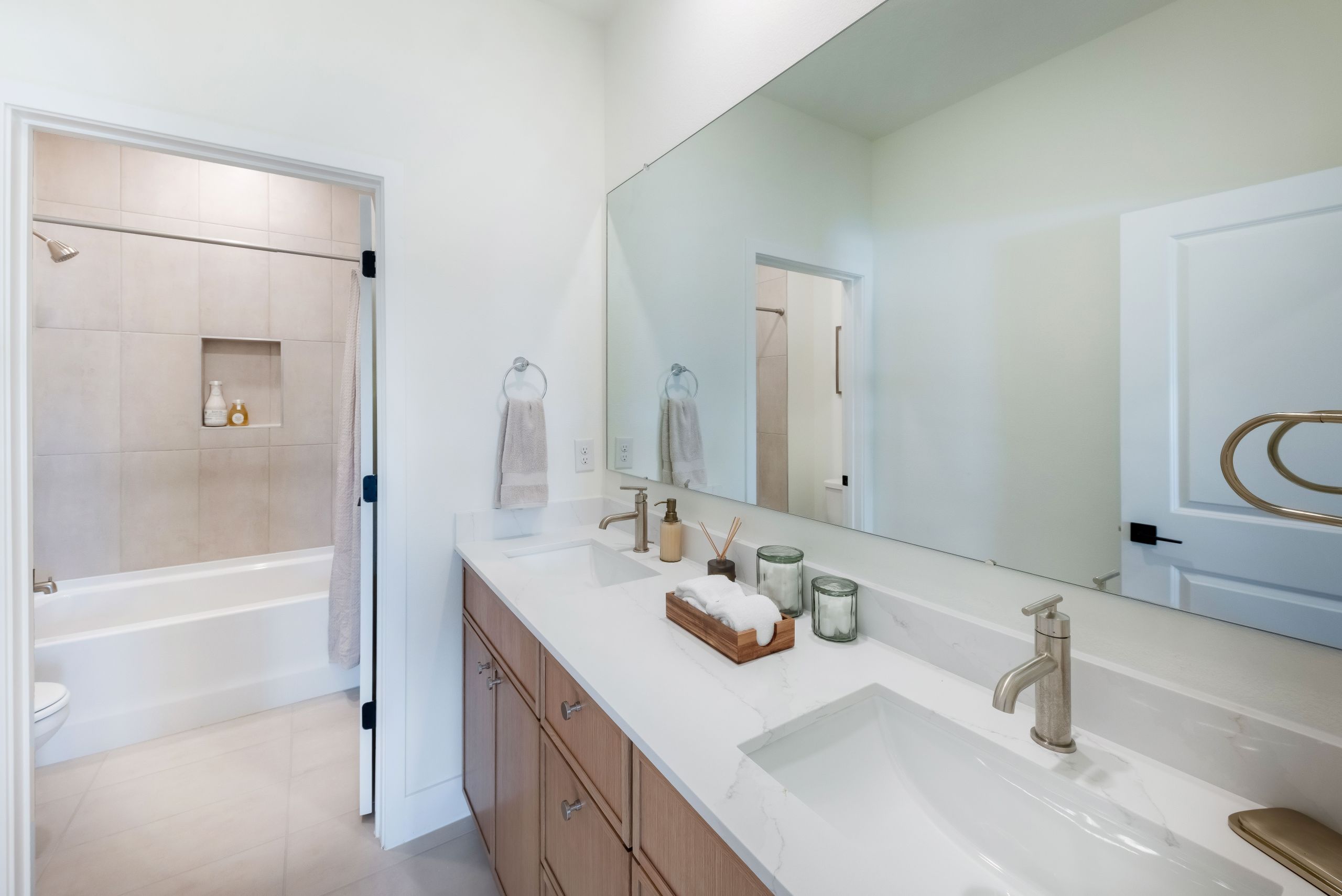 A well-appointed guest bathroom featuring warm finishes and a comfortable design that complements the home’s modern aesthetic.