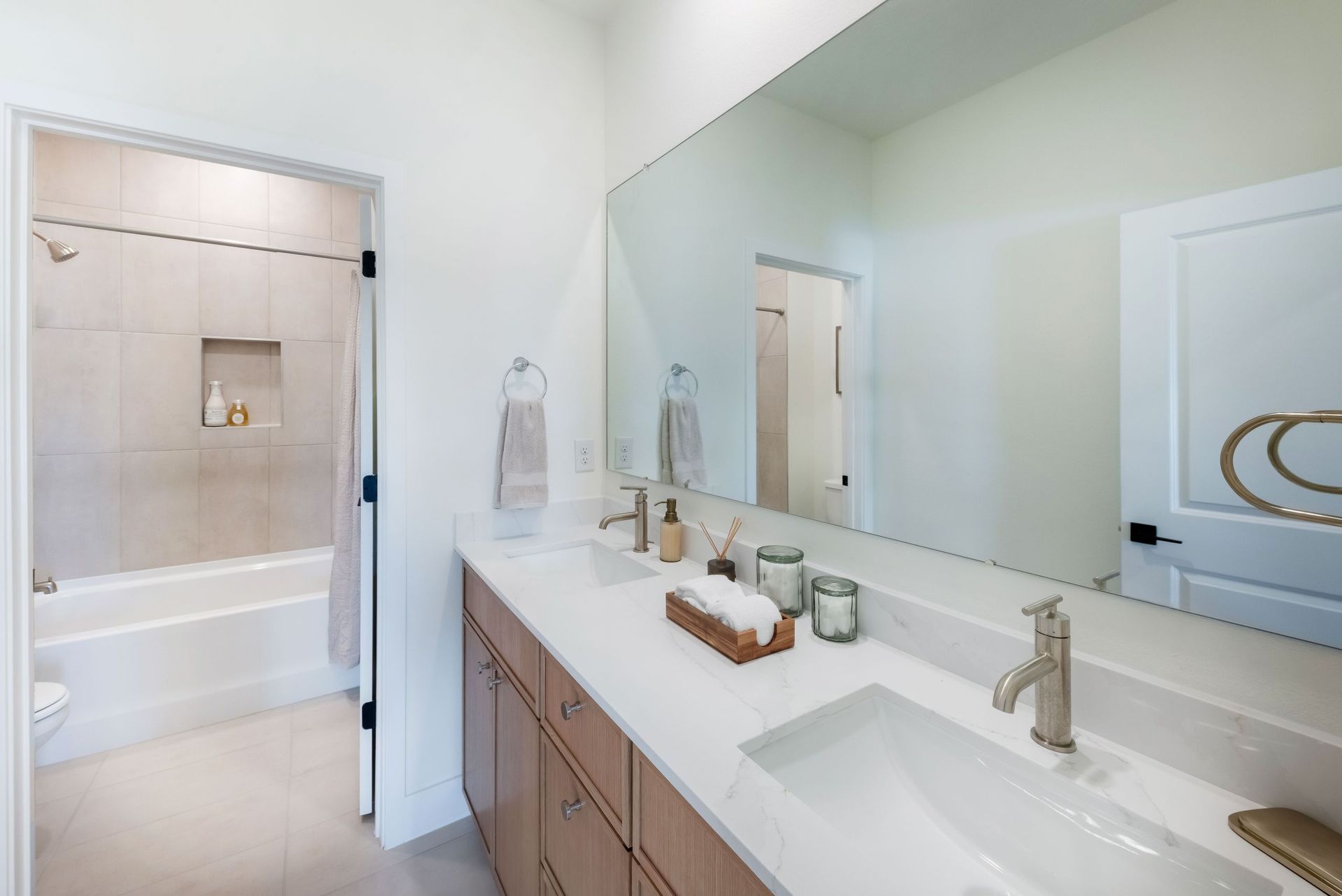 A well-appointed guest bathroom featuring warm finishes and a comfortable design that complements the home’s modern aesthetic.