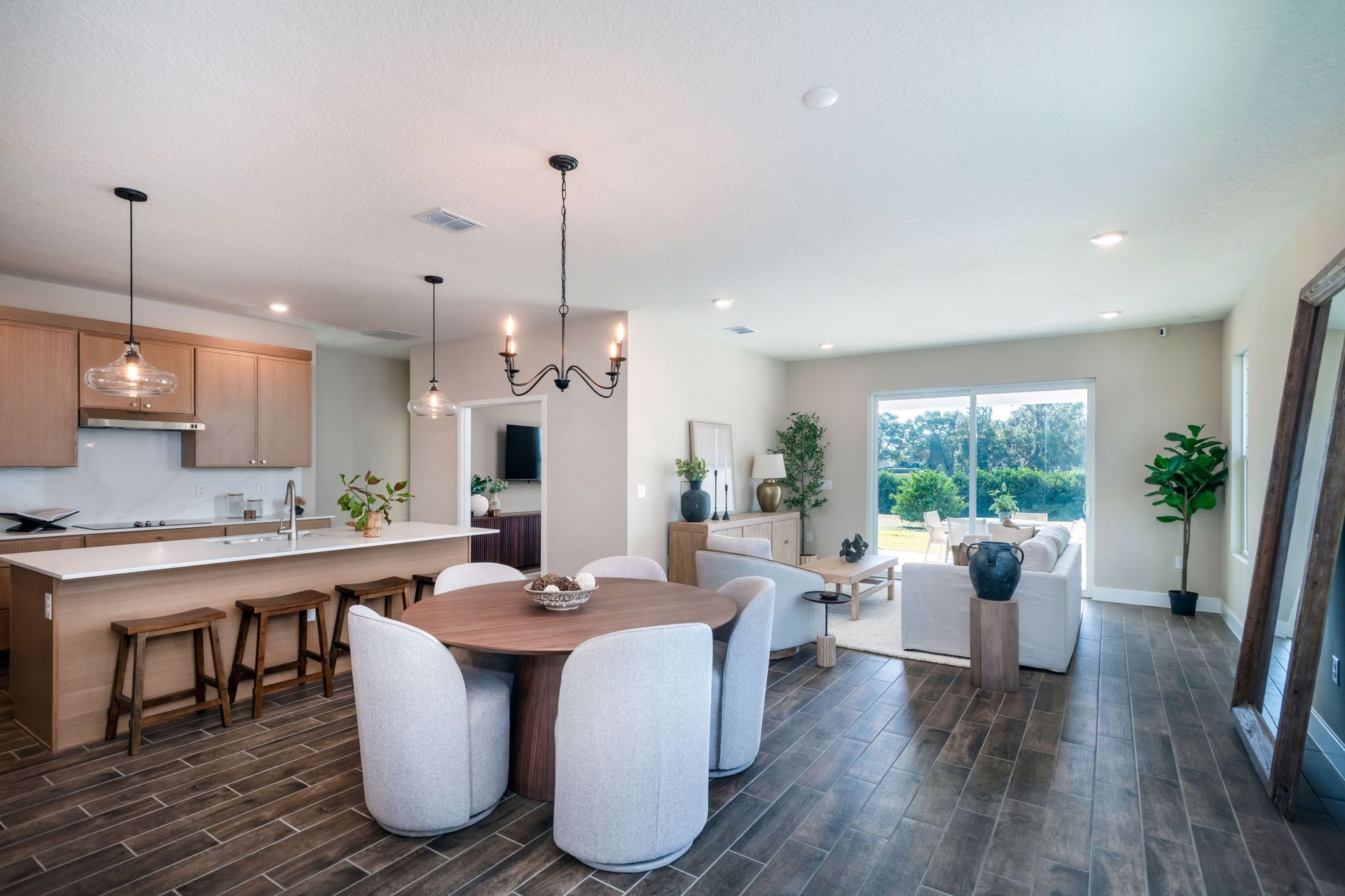 A bright open-concept dining and kitchen area featuring modern finishes, spacious cabinetry, and seamless flow for effortless entertaining.