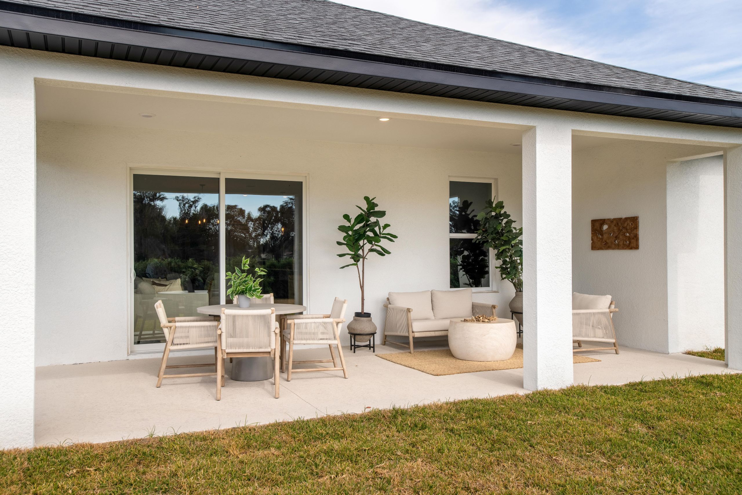 A relaxing covered lanai designed for year-round outdoor enjoyment, with space for dining, lounging, and taking in the natural surroundings.